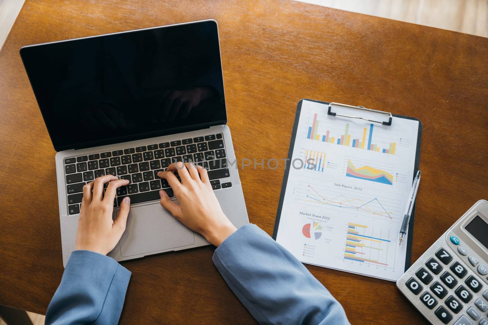 Businesswoman checking and analysing report, Accountant calculate financial report, top view business woman working on laptop computer with chart graphs and calculator, finance analysis concept