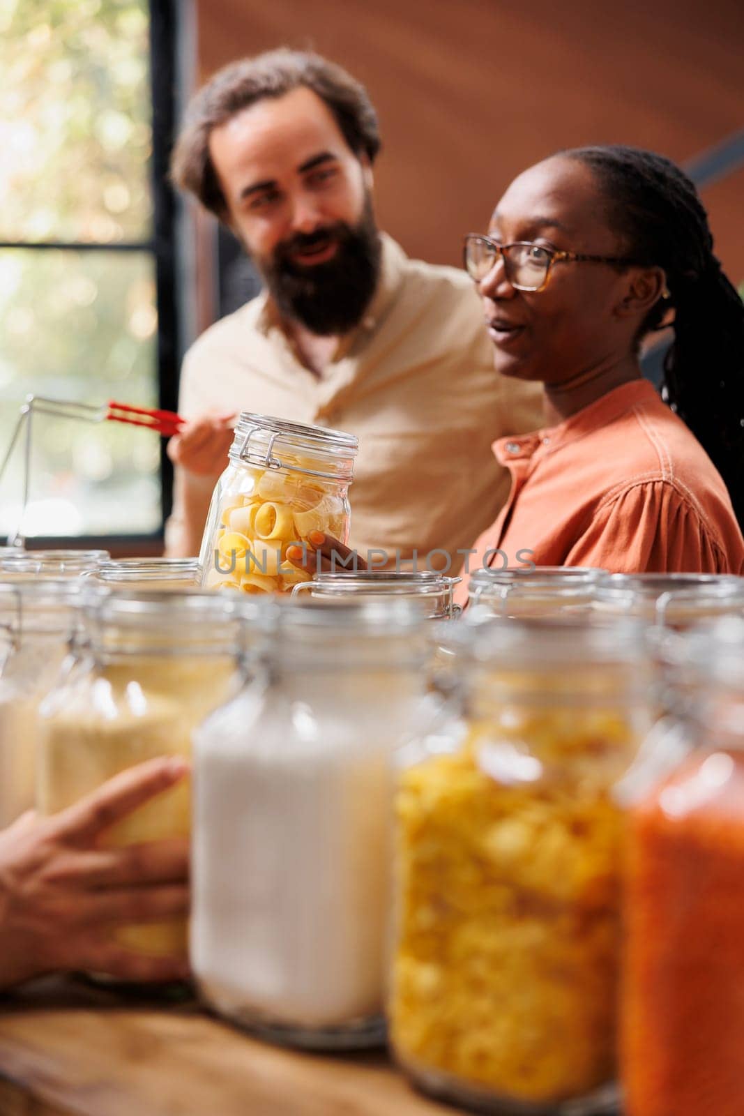 Black woman holding jar of pasta by DCStudio