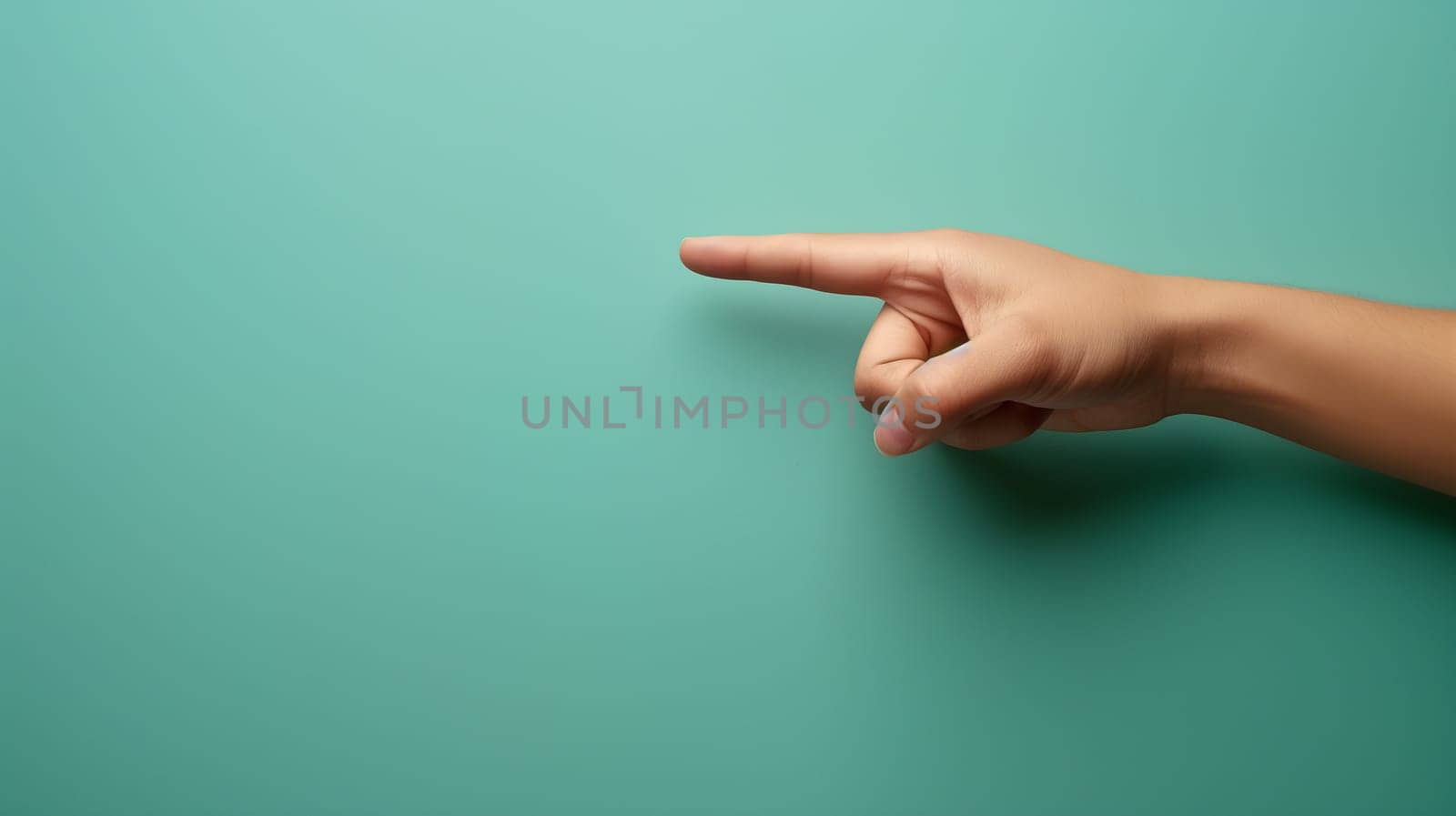 A close-up of a persons right hand extended and pointing towards the right side, set against a plain teal backdrop - Generative AI