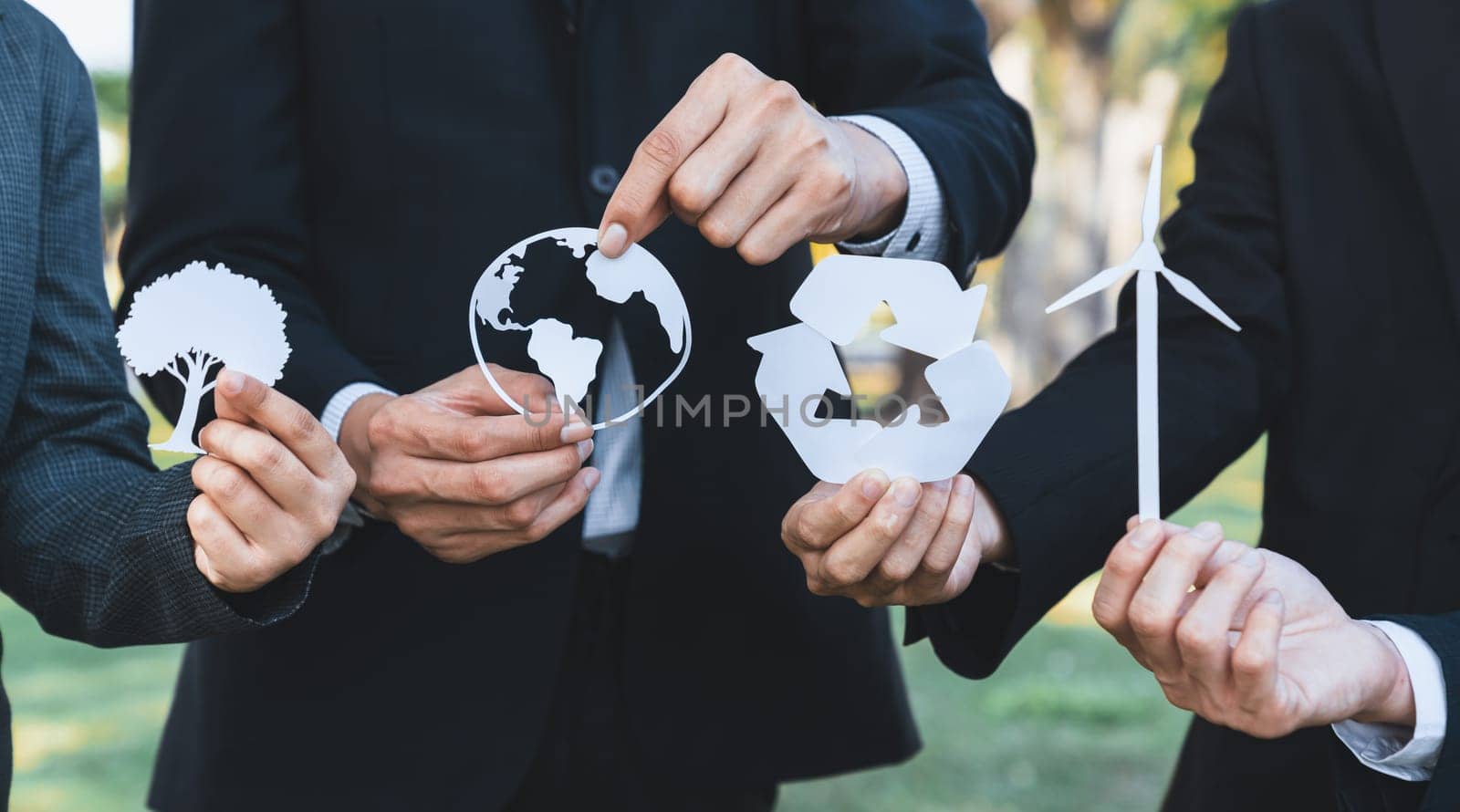 Business people holding eco alternative energy and recycle icon as CSR or corporate social responsibility as to utilize renewable and sustainable power technology for greener environment. Gyre