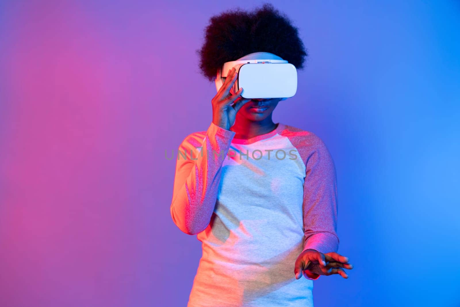 Young African wearing VR through meta select 3D hologram data app. Contrivance. by biancoblue