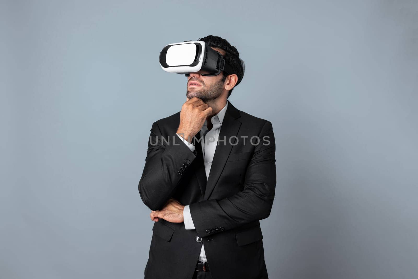 Smart caucasian businessman thinking and planning strategy while using VR glasses. Professional project manager checking financial plan and enter and visit metaverse while wearing headset. Deviation.