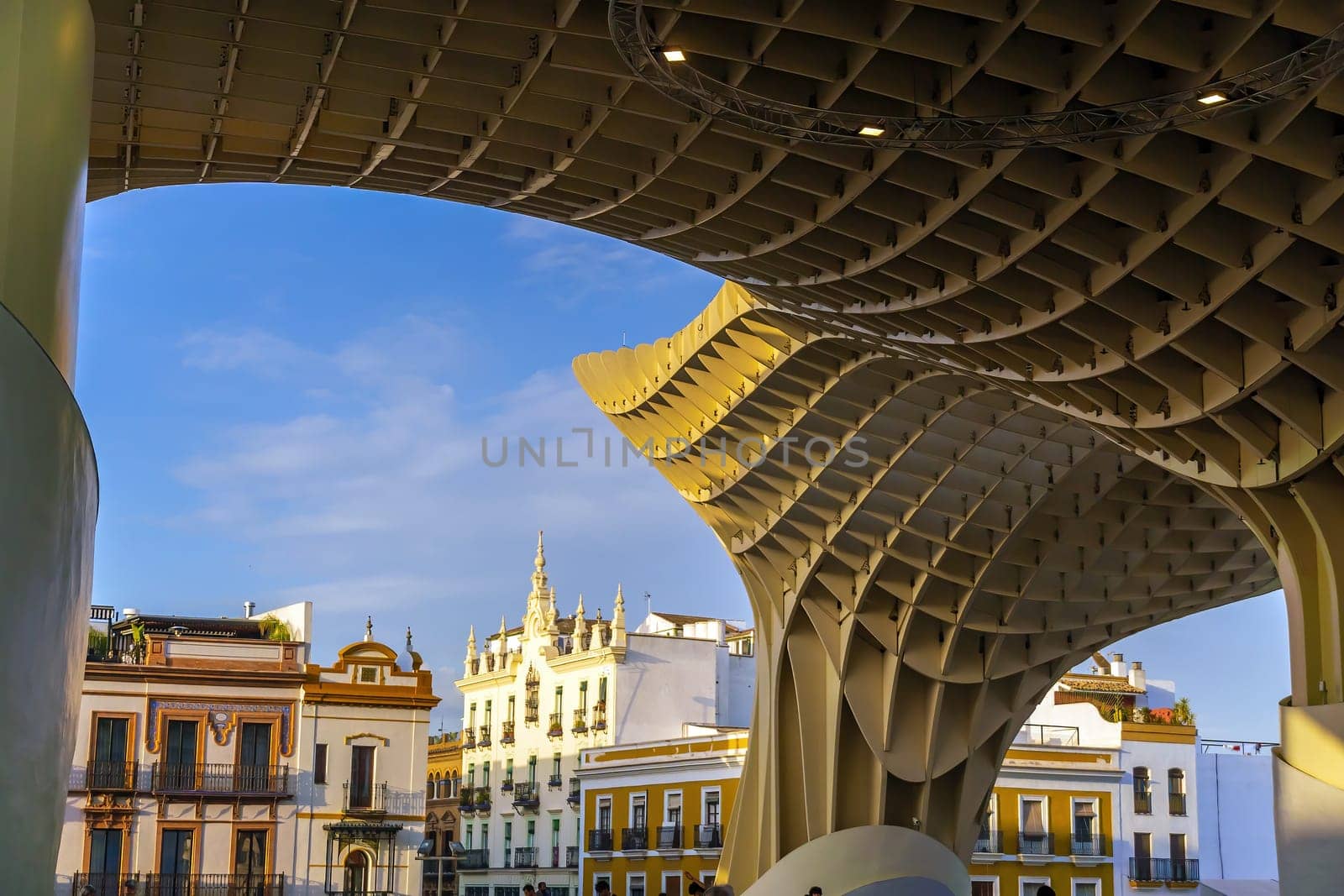 Metropol Parasol wooden structure with Seville city skyline in the old quarter of Seville in Spain at sunset
