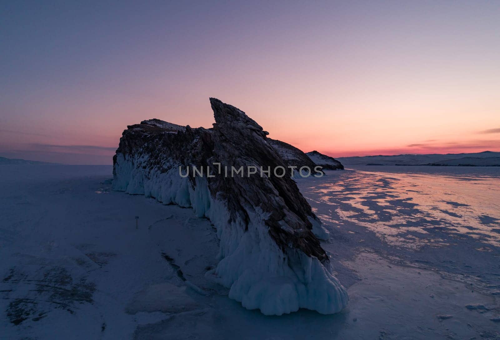 Ogoy island on winter Baikal lake. Winter scenery of Dragon Tail Rock on Ogoy island during sunrise at Lake Baikal.