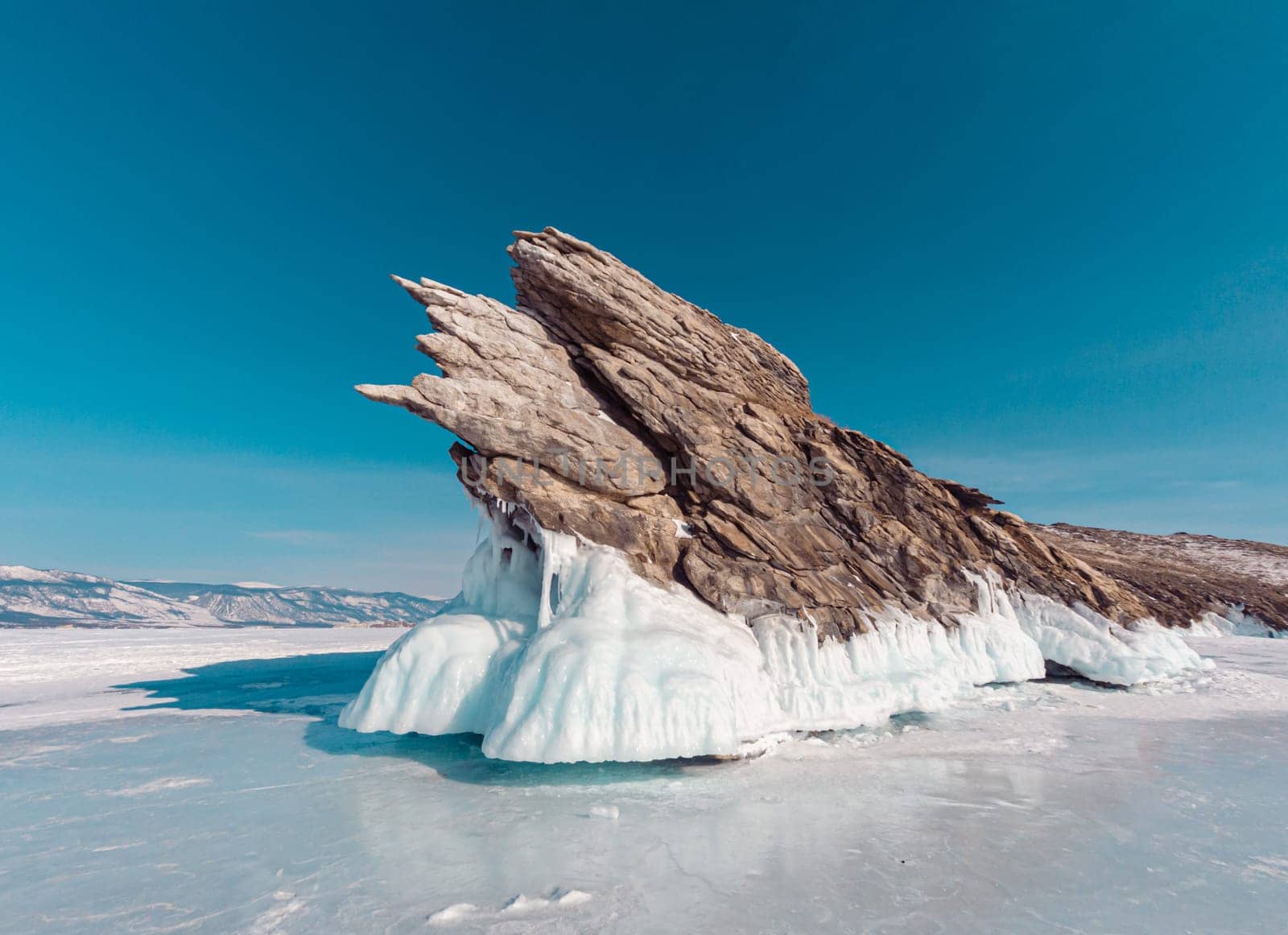 Ogoy island on winter Baikal lake. Winter scenery of Dragon Tail Rock on Ogoy island at Lake Baikal.