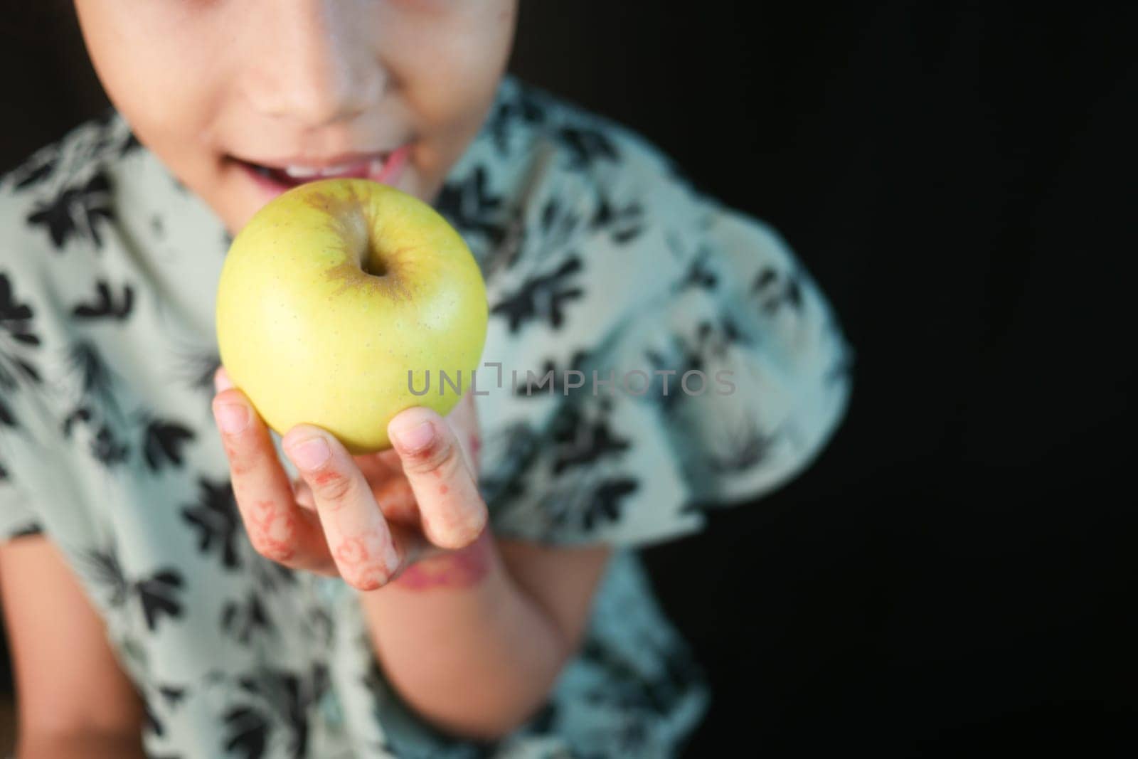 little girl eating apple close up .