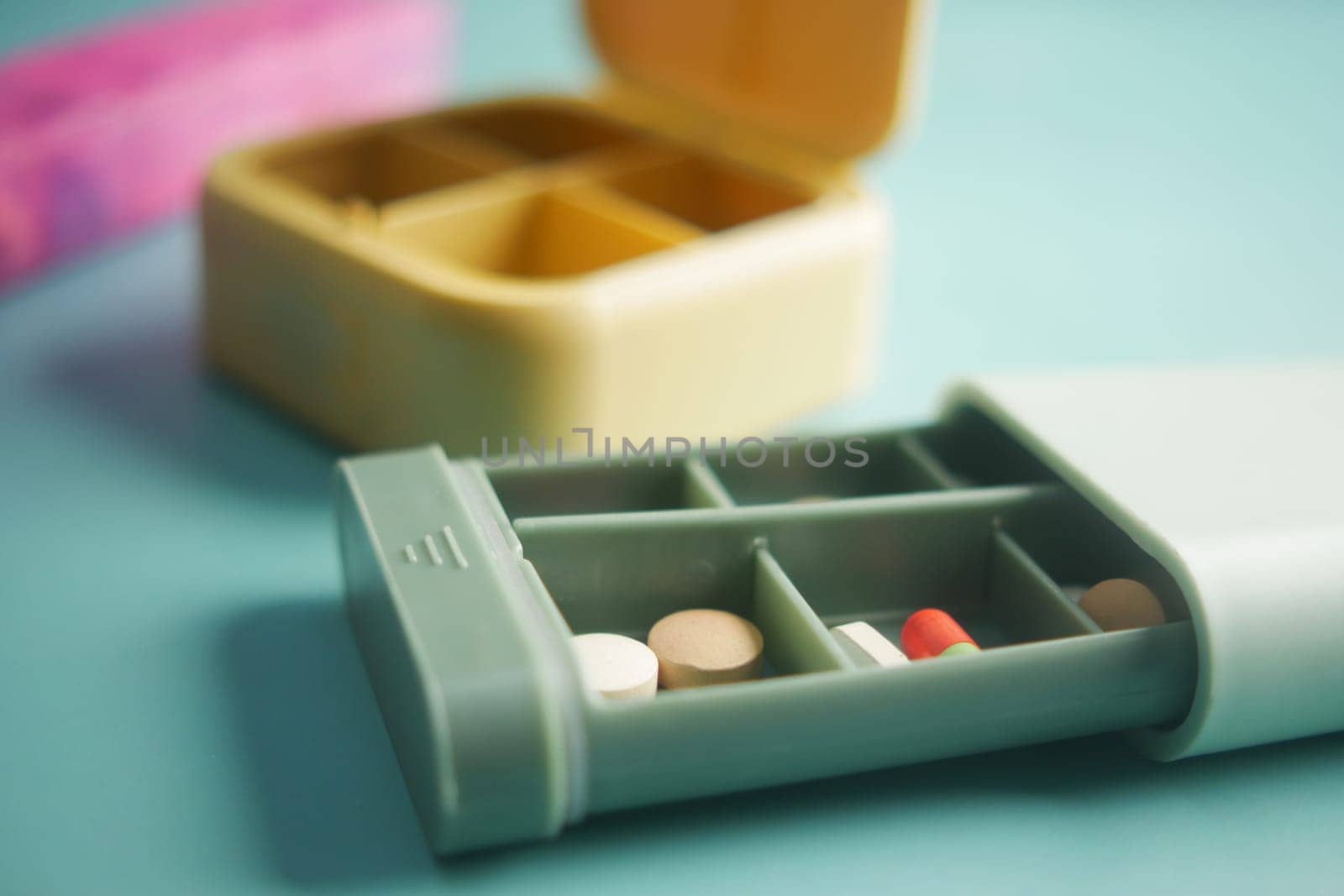 close up of medical pills in a pill box on table .