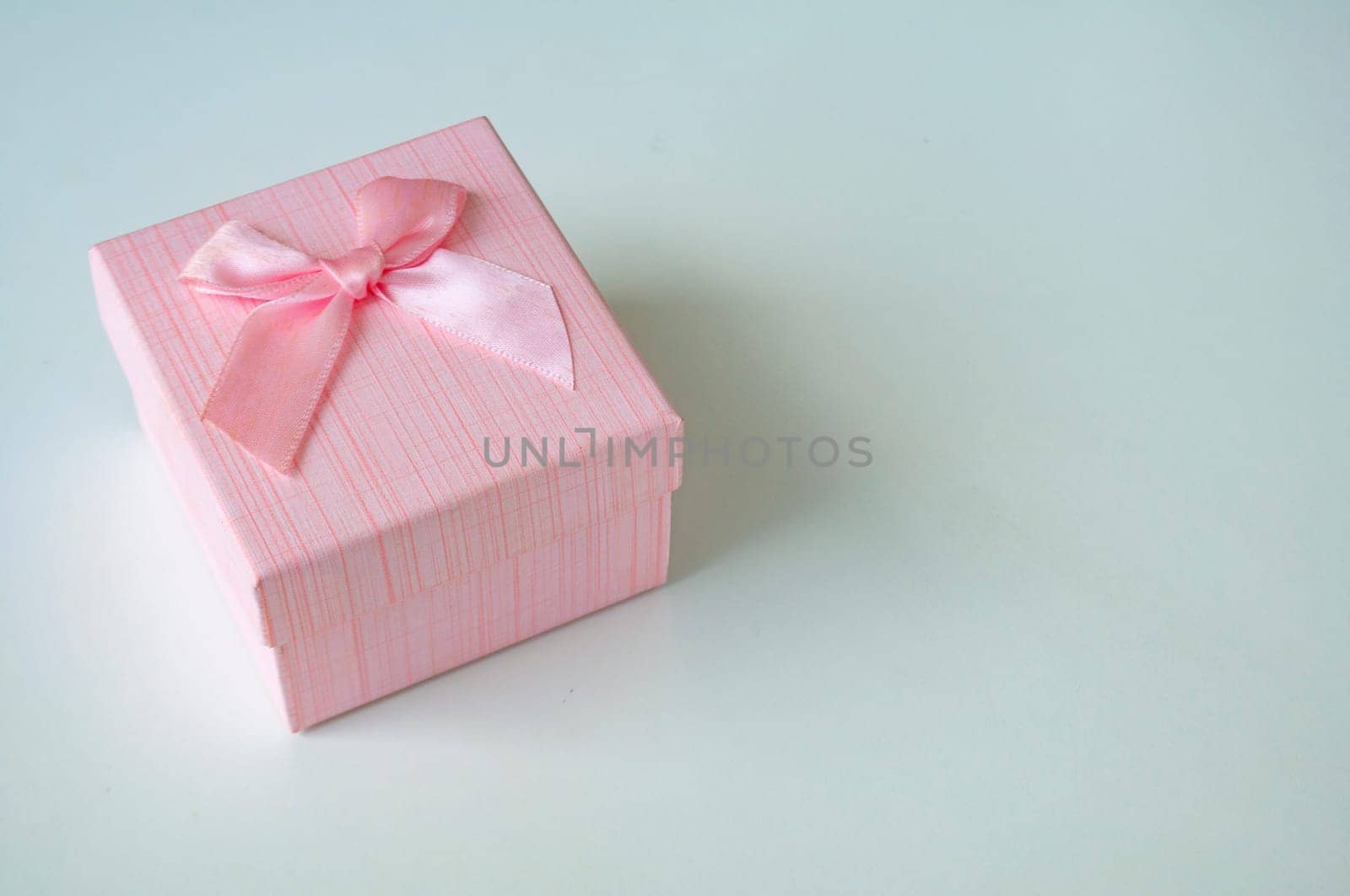 Pink color present on white background with customizable space for text. Copy space and celebration.