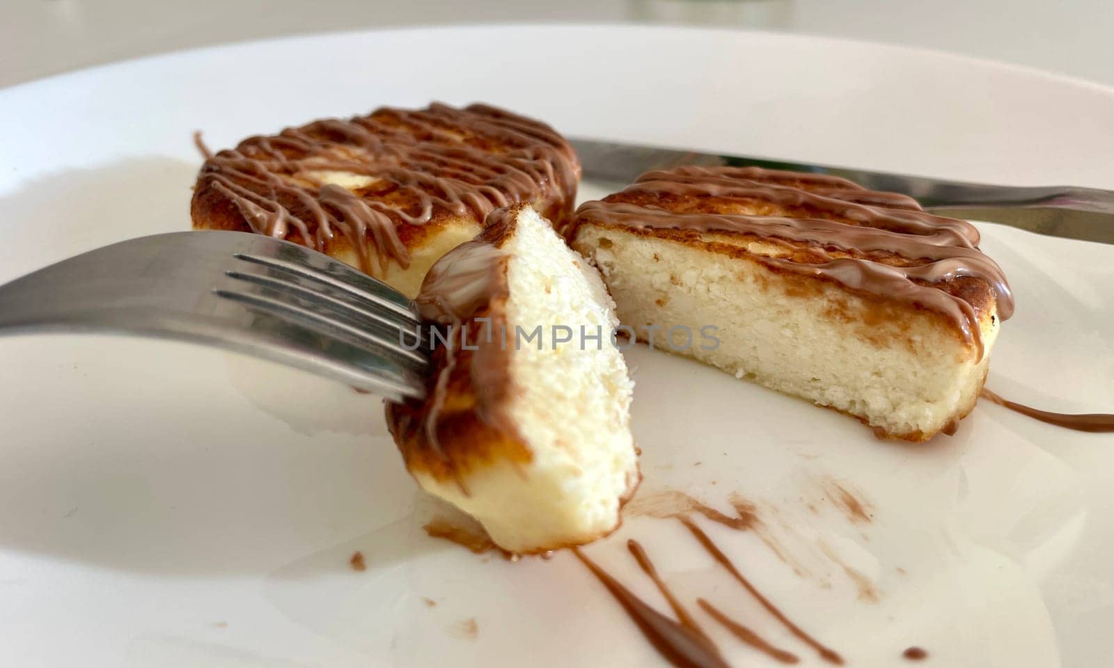Two cheesecakes for breakfast on a white plate. High quality photo