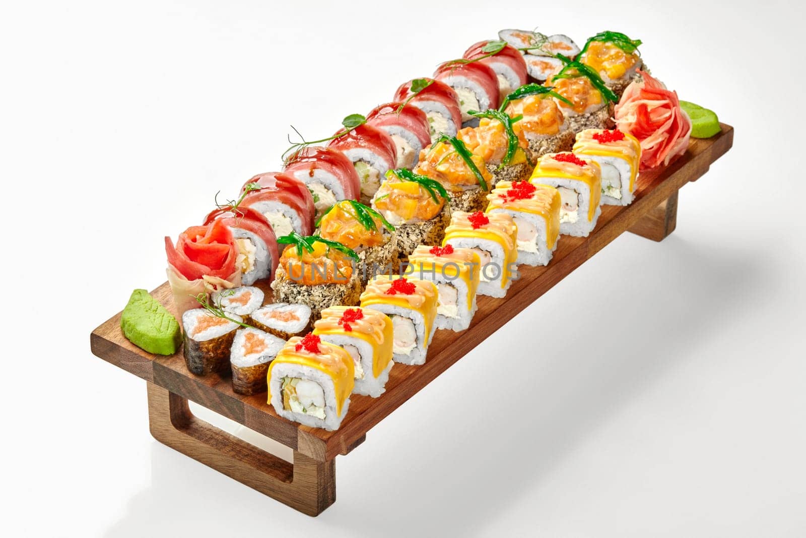 Wooden tray with various sushi rolls isolated on white by nazarovsergey