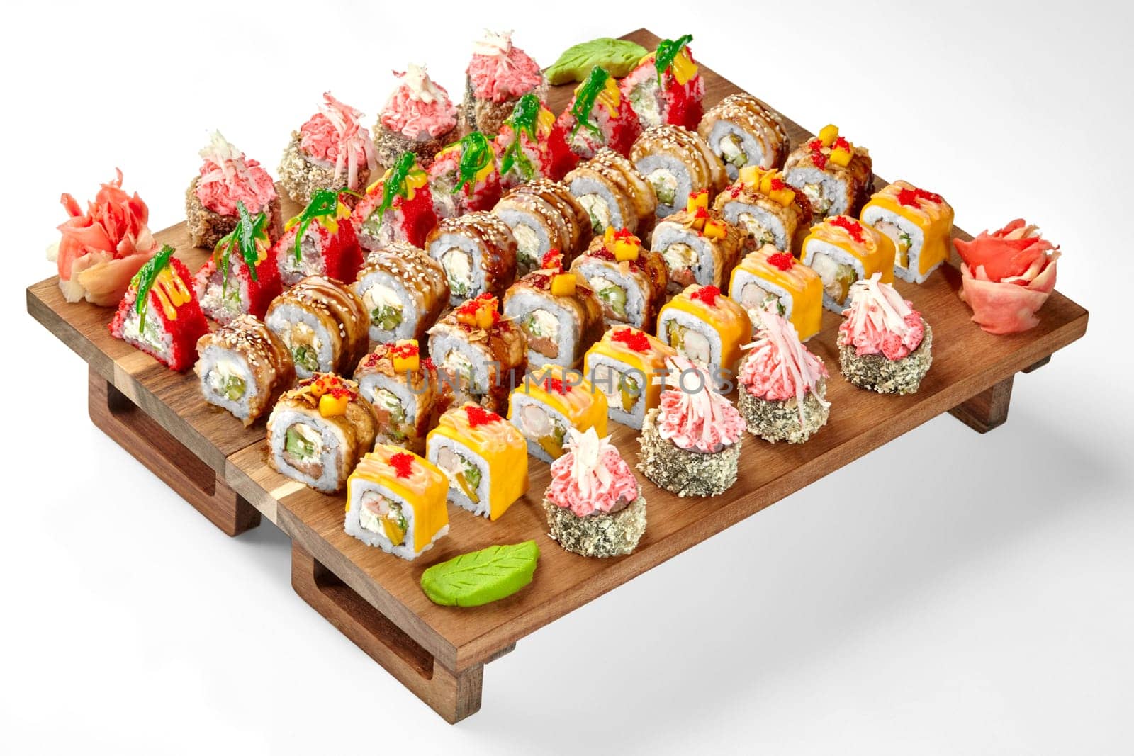 Colorful set of sushi rolls on wooden serving tray by nazarovsergey