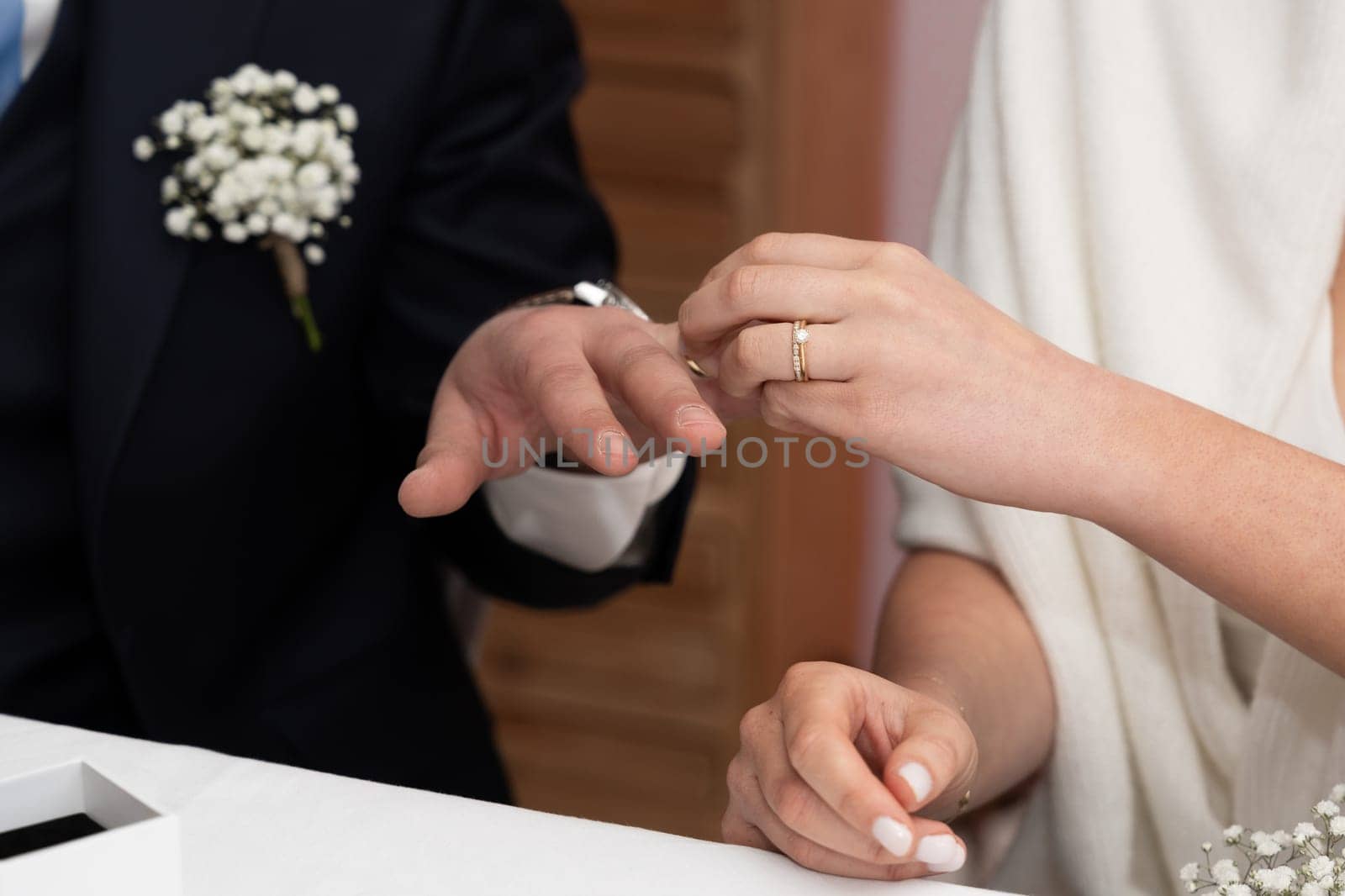 The bride puts a ring on the groom's finger Just married