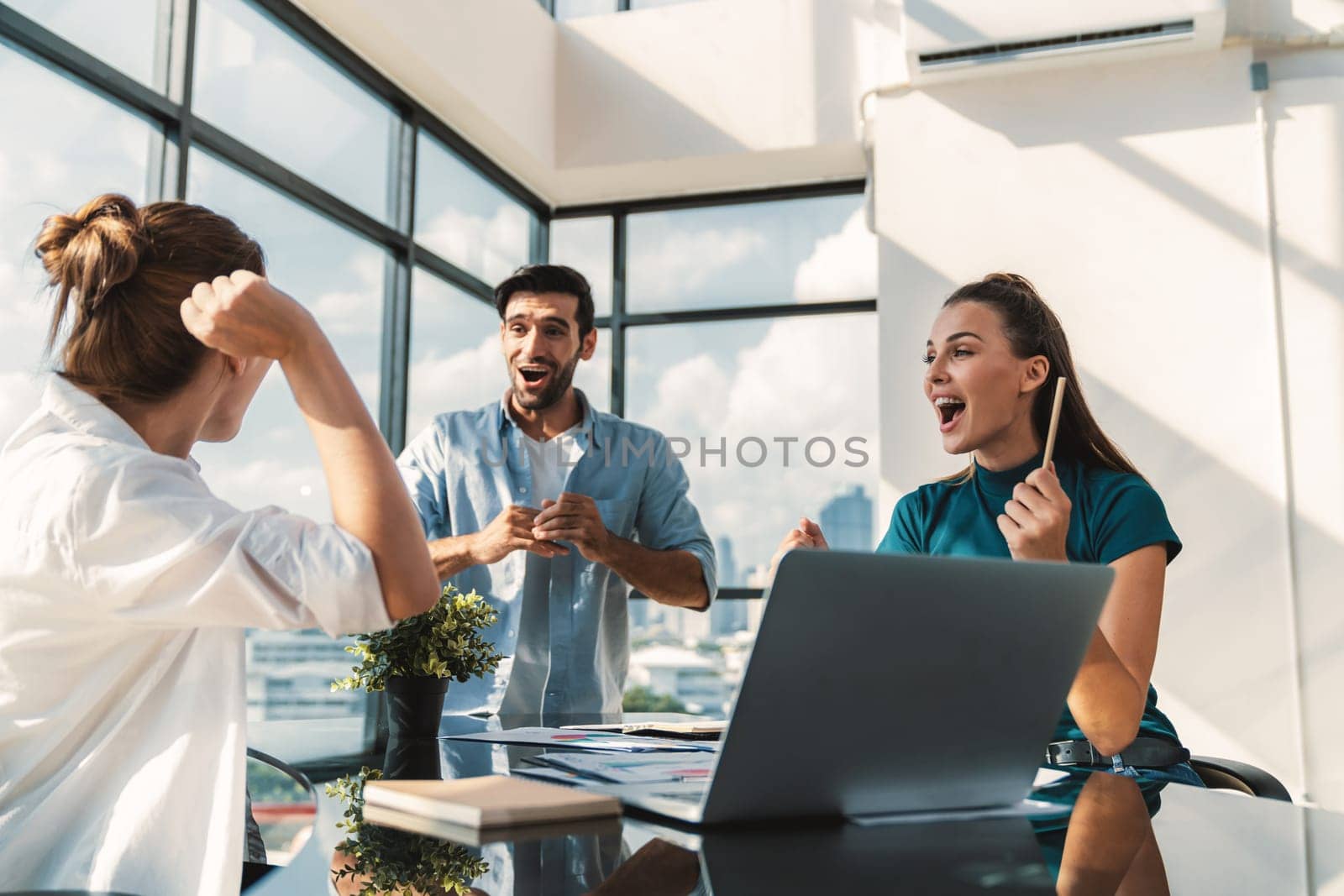 Group of happy businesspeople celebrate their successful project. Professional business team win and proud of their project at modern office. Successful teamwork, happy colleague, workplace. Tracery.