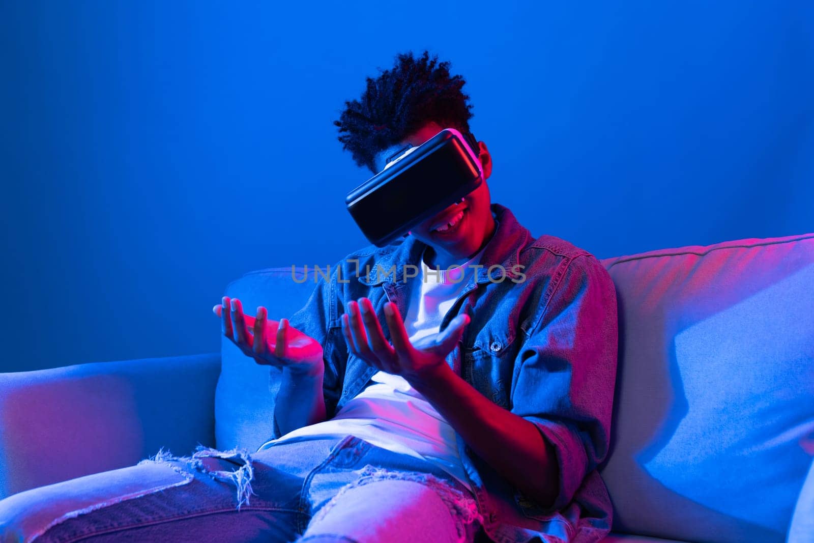 Young African looking VR watching 3D pointing interesting object. Contrivance. by biancoblue