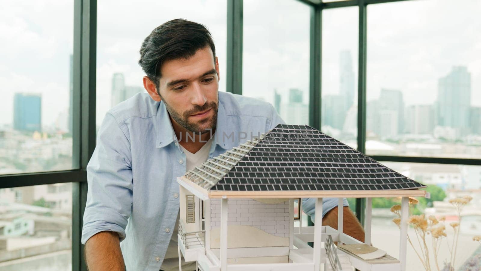 Professional architect engineer check, inspect, look architectural model at modern office with skyscraper, cityscape view. Skilled project manager or businessman check house construction. Tracery