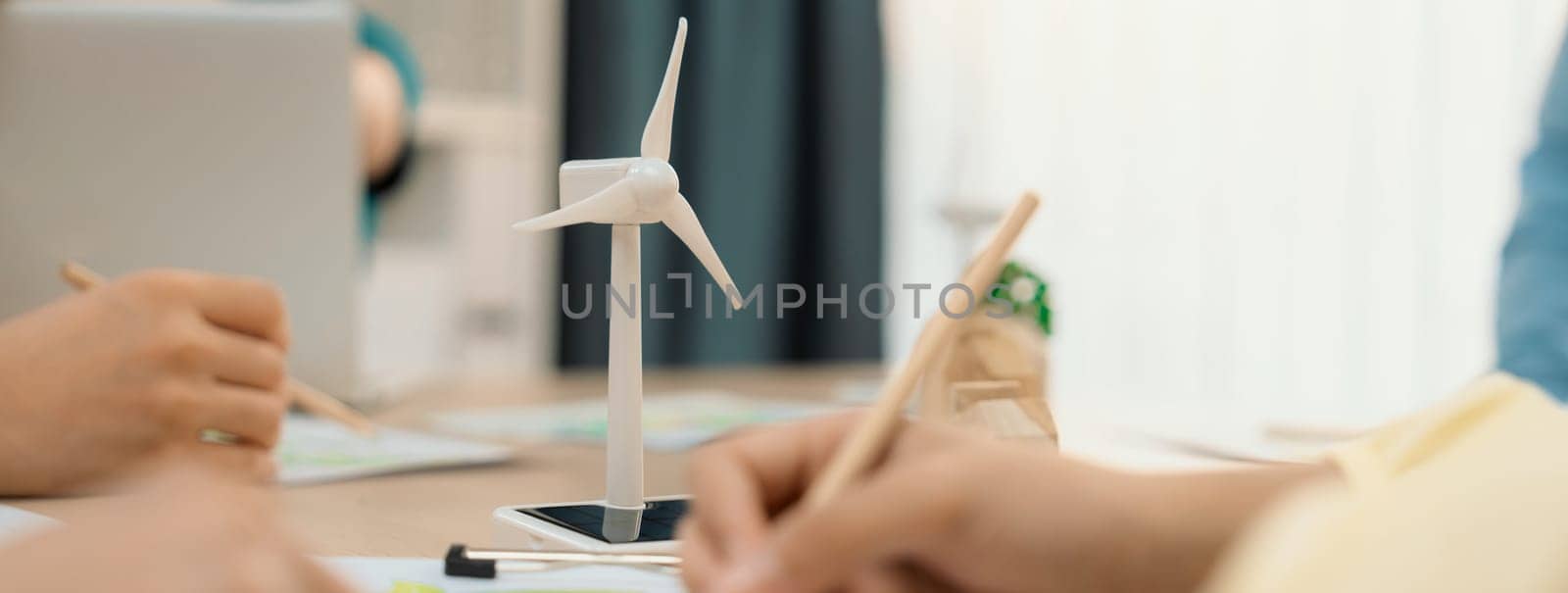 Green business meeting represented renewable energy. Skilled businesspeople discuss green business investment at table with environmental documents. Closeup. Focus on hand. Delineation.