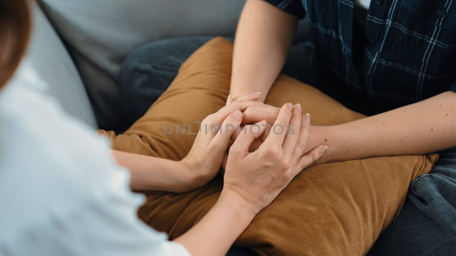 Supportive and comforting hands cheering up depressed patient person or stressed mind with prim empathy. Psychologist reassuring stressful and sad patient in clinic.