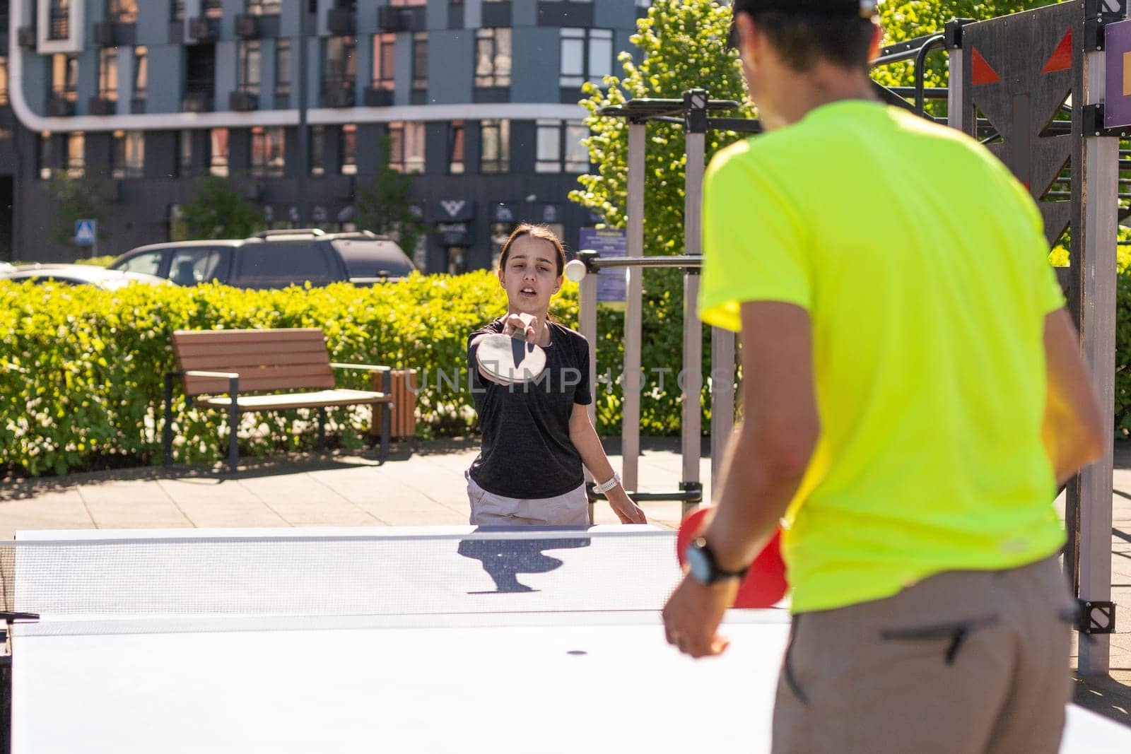 Family playing table tennis outside house. High quality photo