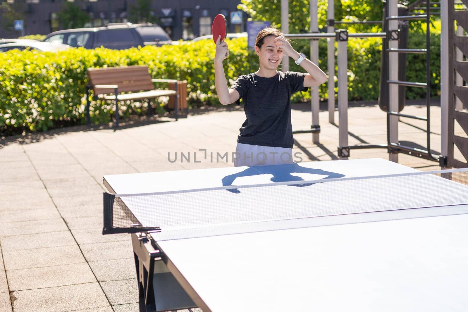 girl plays in table tennis outdoor. High quality photo