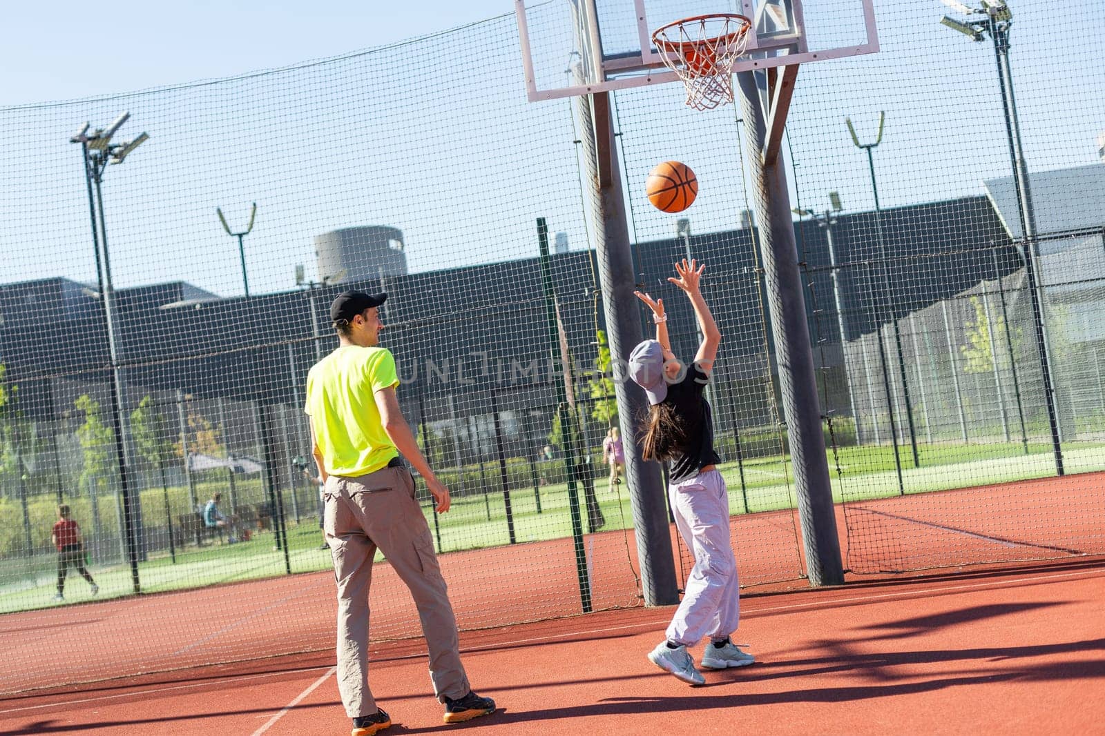 father and daughter playing basketball together on playground. High quality photo