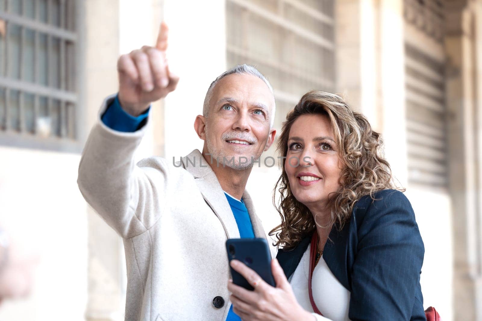 Traveler adult couple using smartphone to search information about hotels, shopping malls and transportation guides on the app. lifestyle and travel concept.