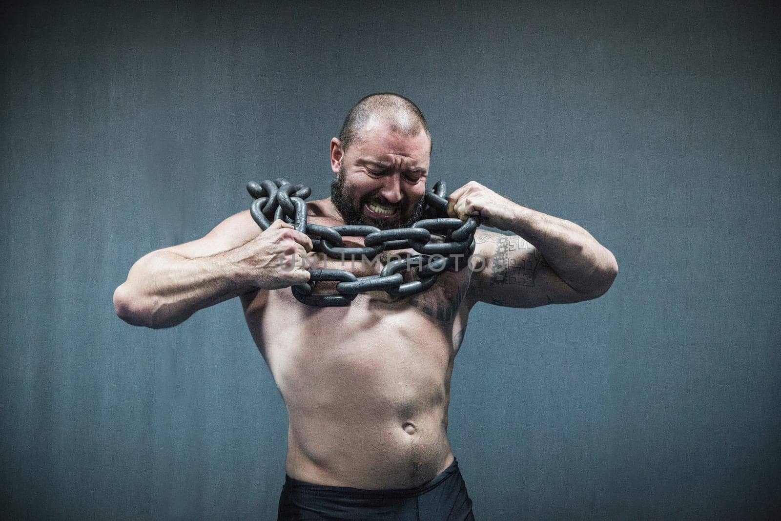 Bila Tserkva, Ukraine, October 15,2016: The athlete breaks the chain by Viktor_Osypenko