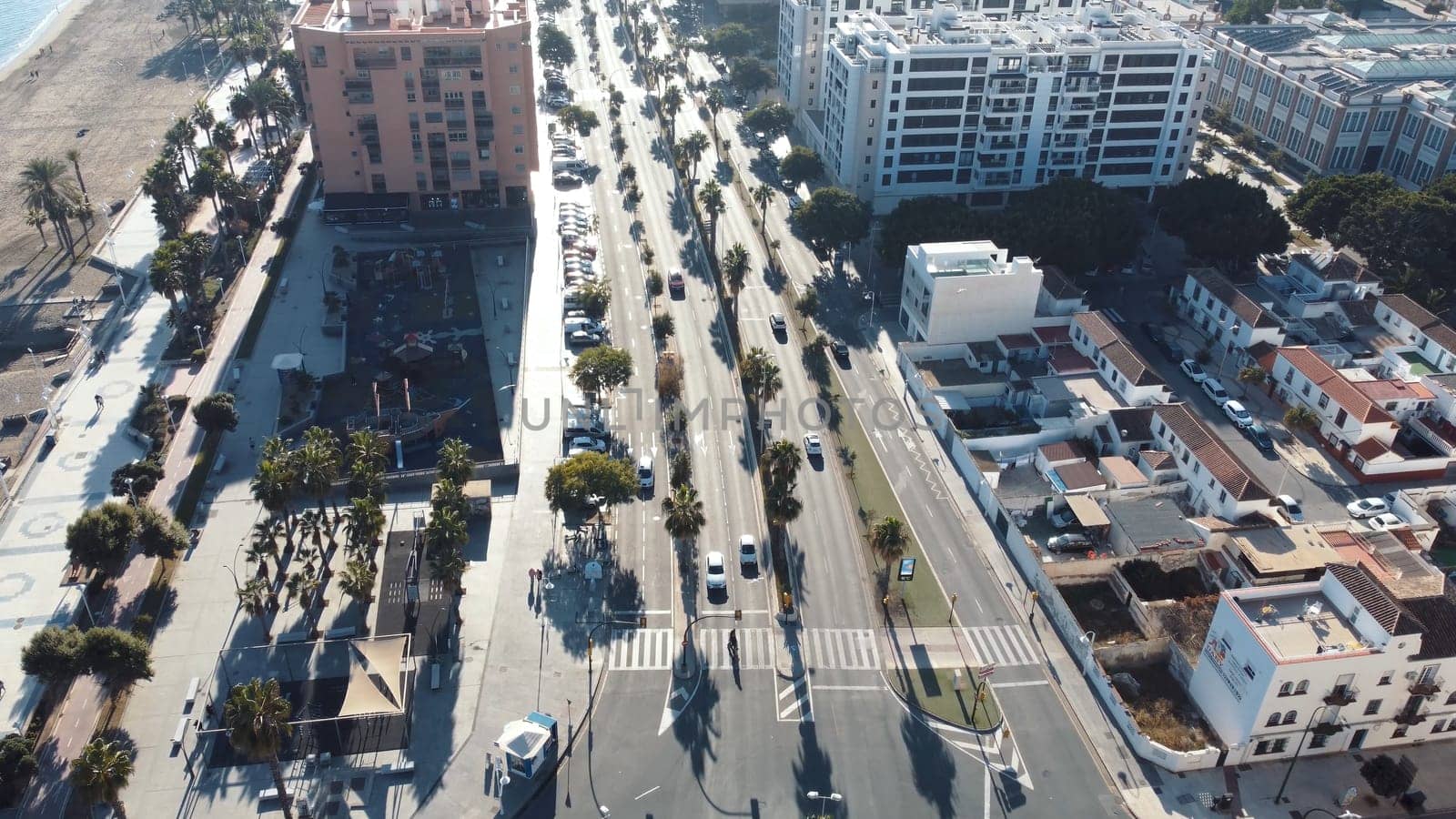 Urban landscape with cars on city street, skyscrapers, water, and trees by igor010