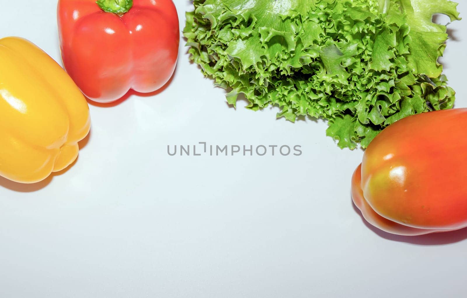 Sweet red and yellow pepper vegetables and green lettuce. Healthy lifestyle.