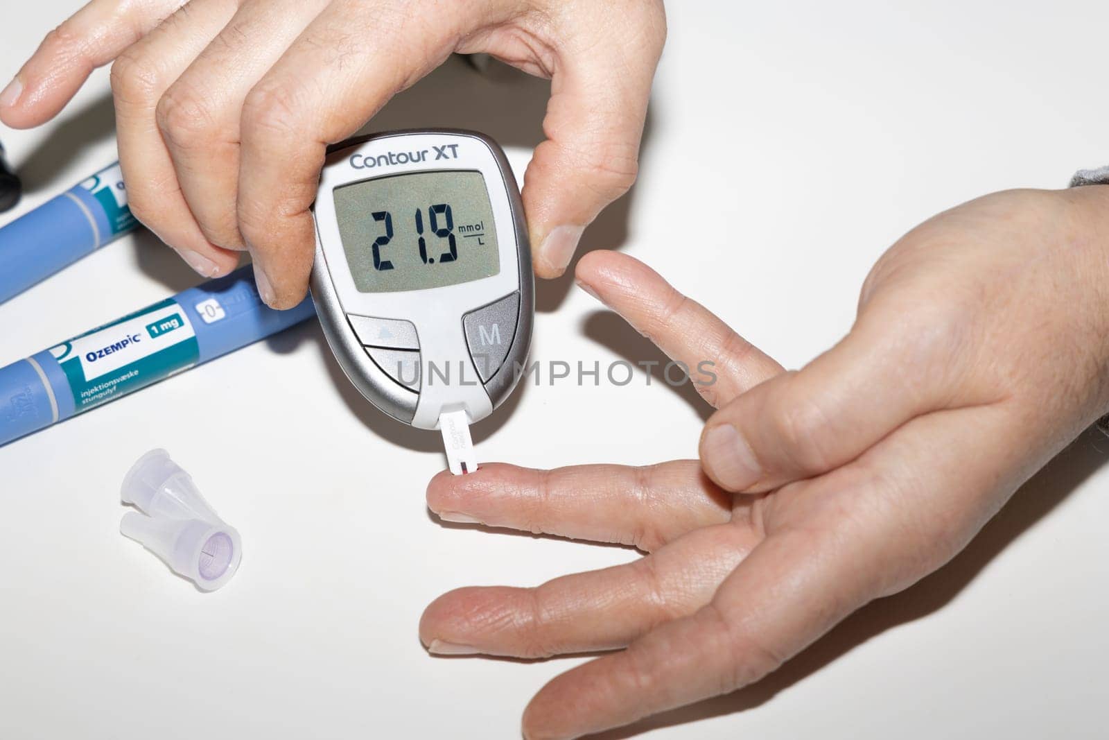 Diabetic man measuring blood sugar level. High blood sugar hyperglycemia. High quality photo