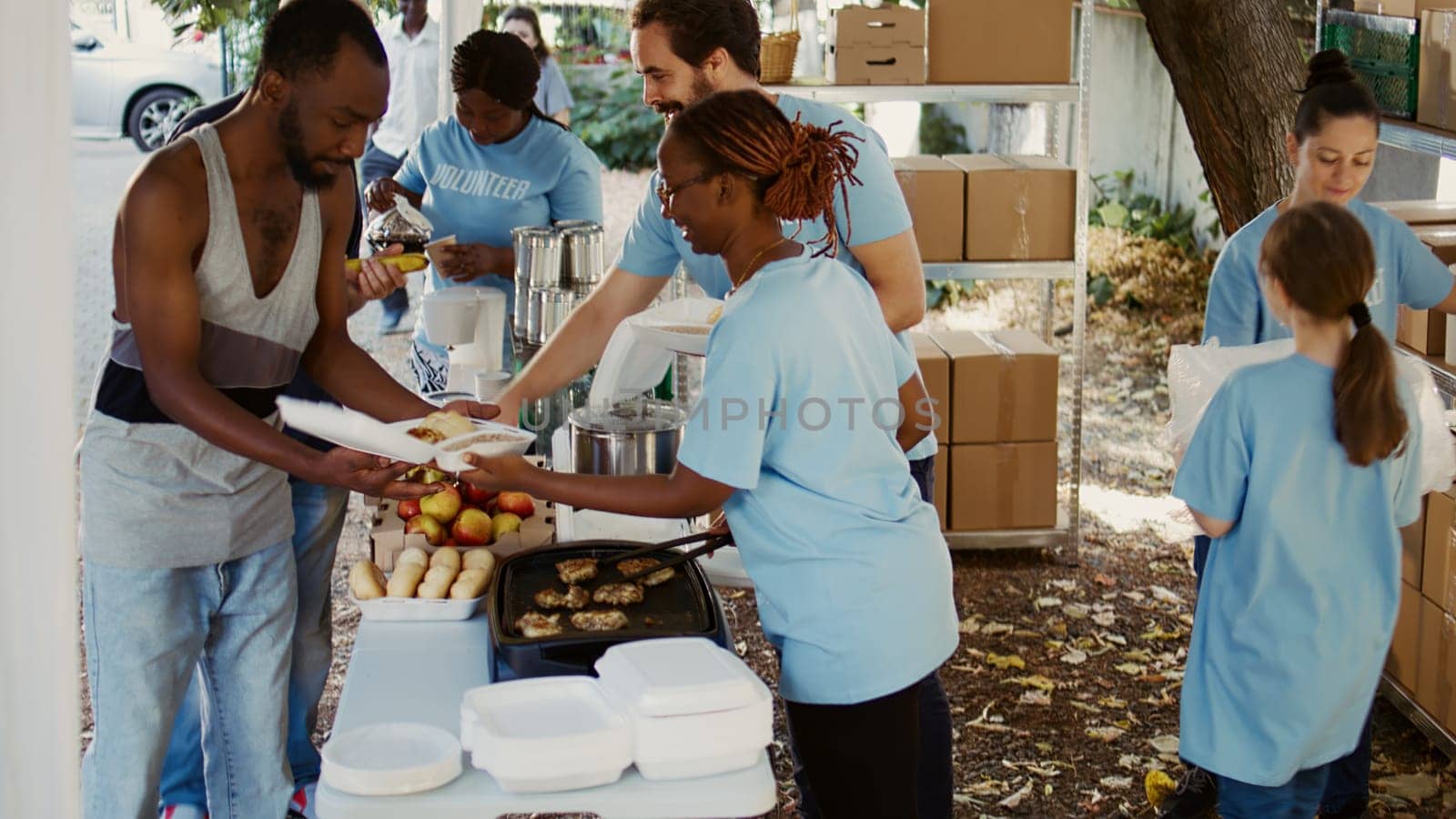 Charity workers giving food to the needy by DCStudio