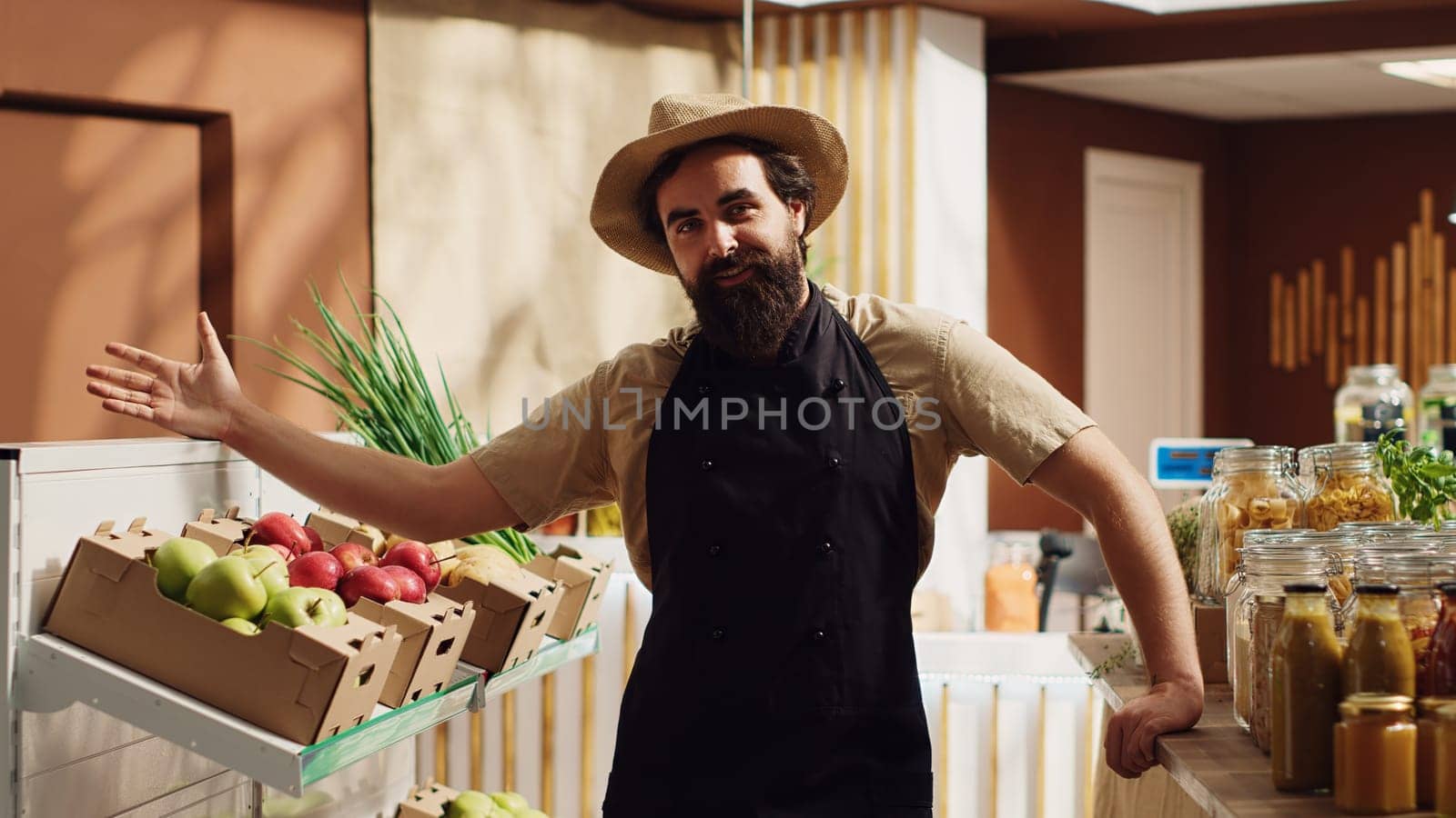 Zero waste supermarket storekeeper participates in TV show segment promoting organic food and vegan lifestyle. Local neighborhood store vendor in front of camera presenting his fresh food