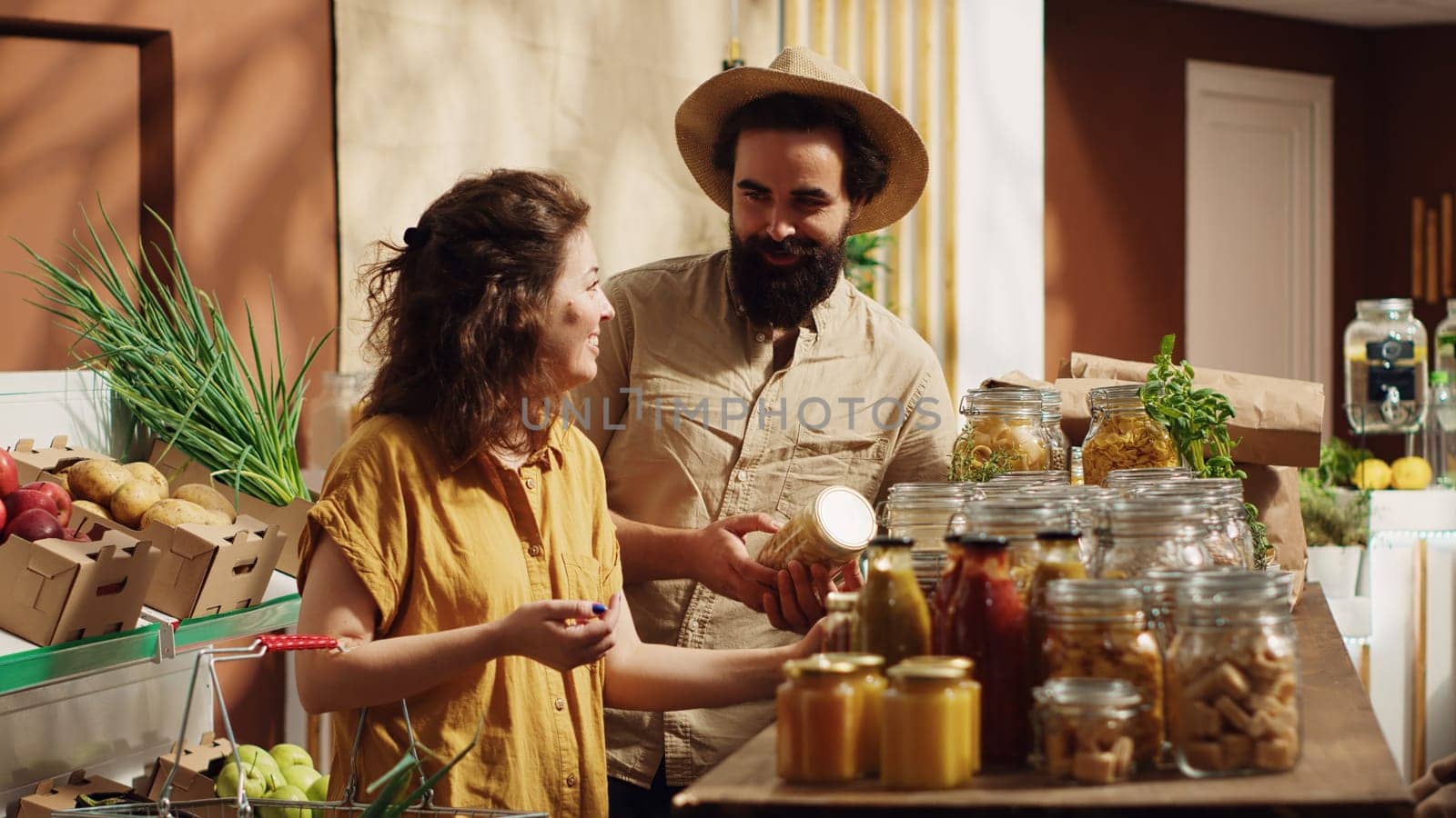 Happy couple buys organic food by DCStudio