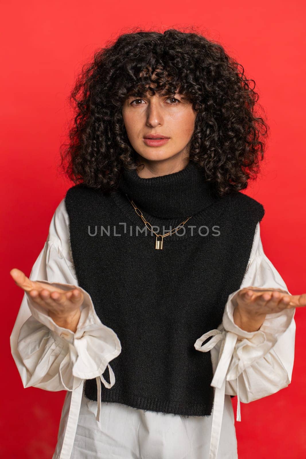 Upset frustrated annoyed woman raising hands in indignant expression, quarreling asking reason of conflict problem why such stubborn. Irritated young girl isolated on red background indoors. Vertical