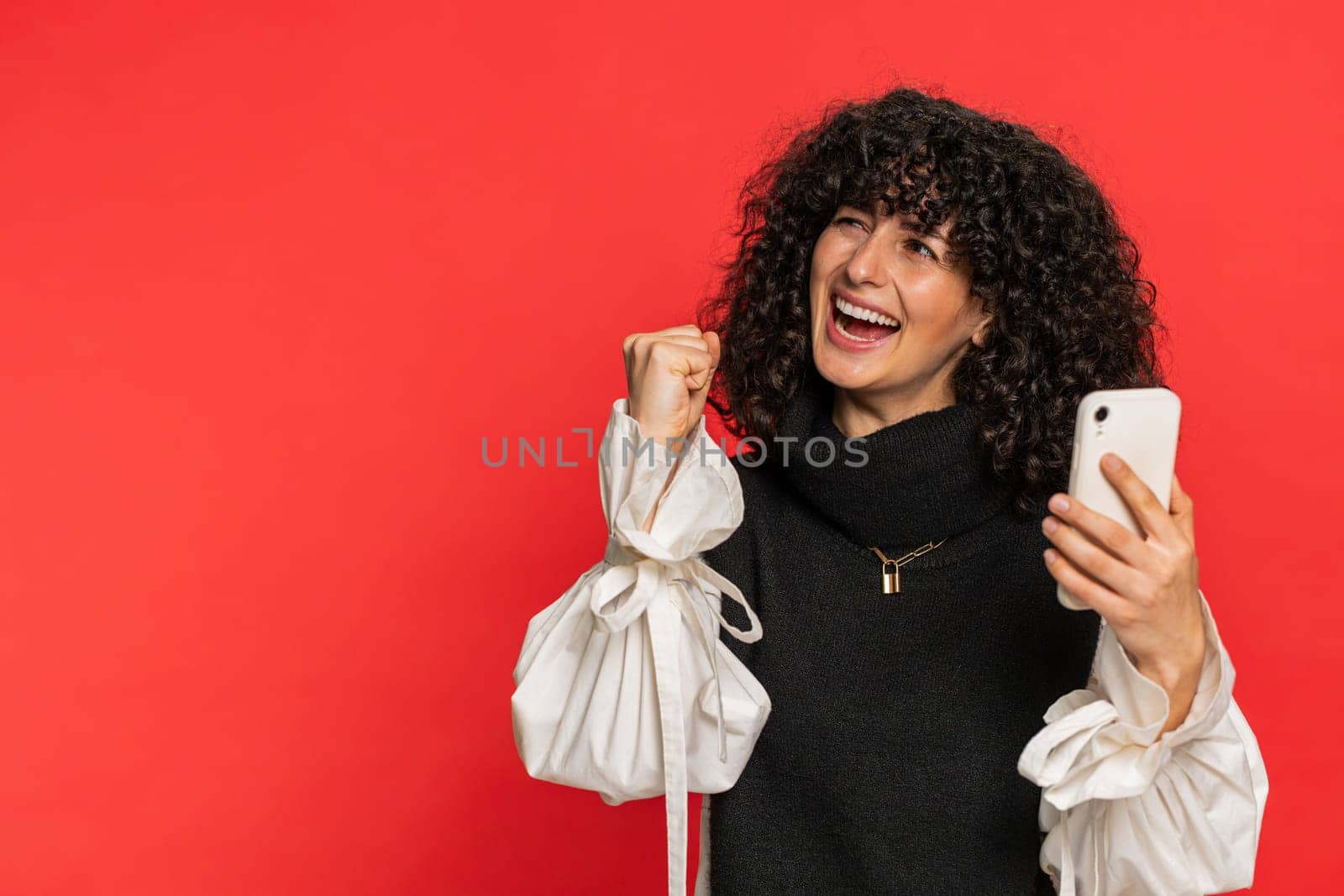 Happy excited Caucasian young woman girl use smartphone typing browsing shouting say wow yes found out great big win good news lottery goal achievement celebrating success, winning play game on red