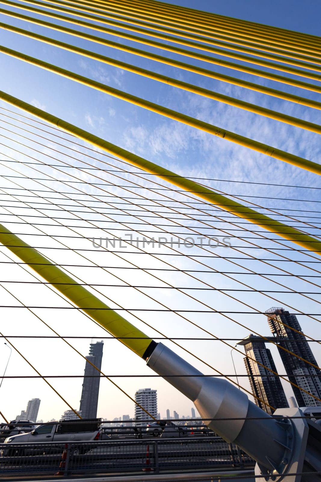 Yellow Cables On A Suspension Bridge Against Blue Sky In Bangkok by urzine