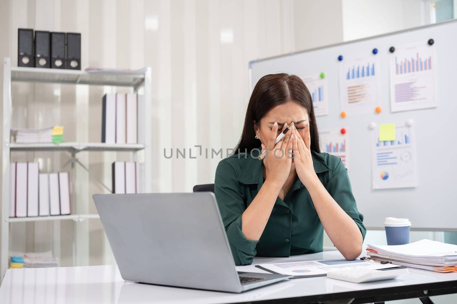 Young businesswoman has problems with her work in the office Feeling stressed and unhappy, showing a serious expression.