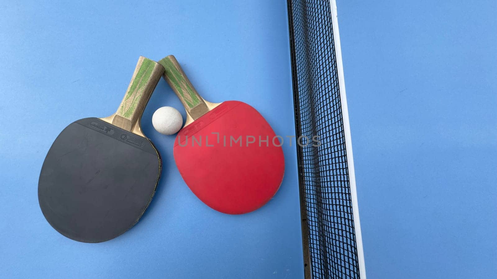 Table tennis rackets and ball on tennis table. High quality photo