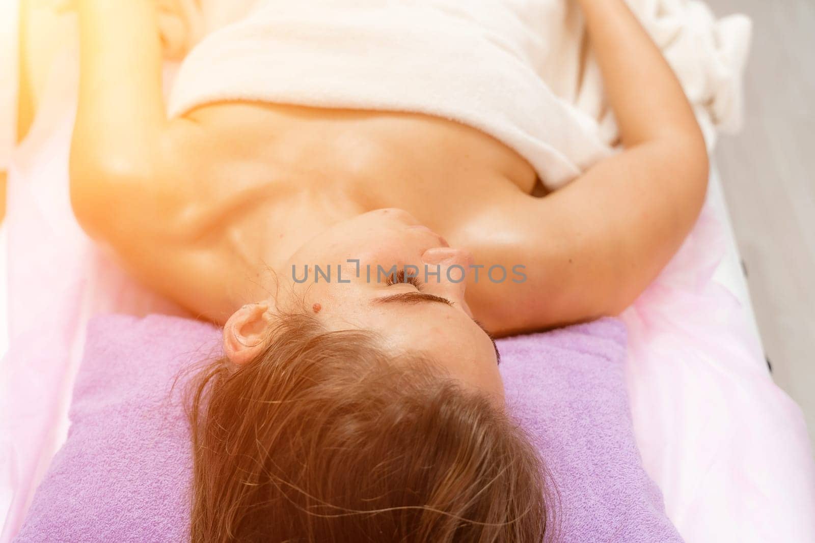 Facial massage. A woman is given a massage in a beauty salon. Close-up.