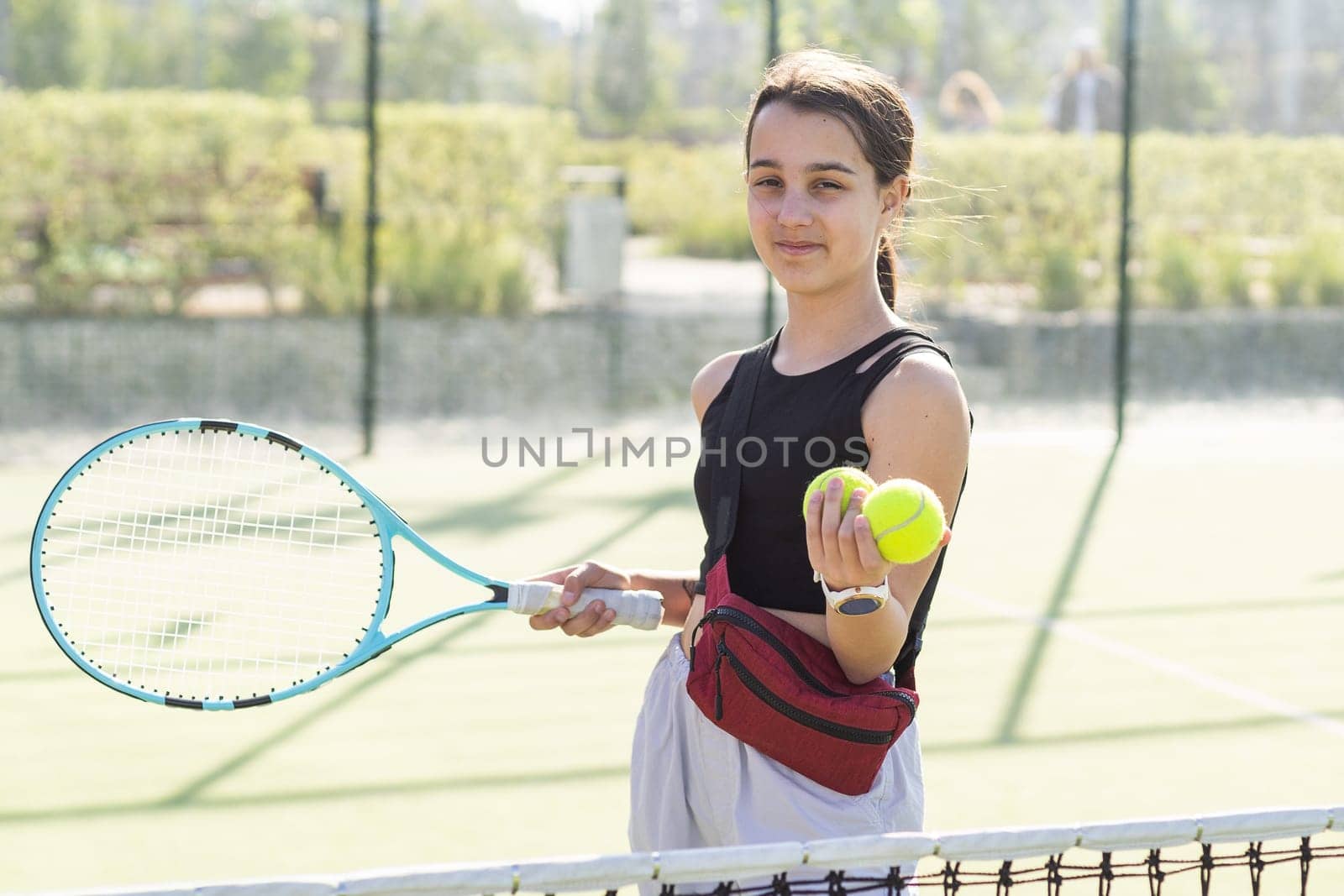 Girl with a racket on the tennis court. High quality photo