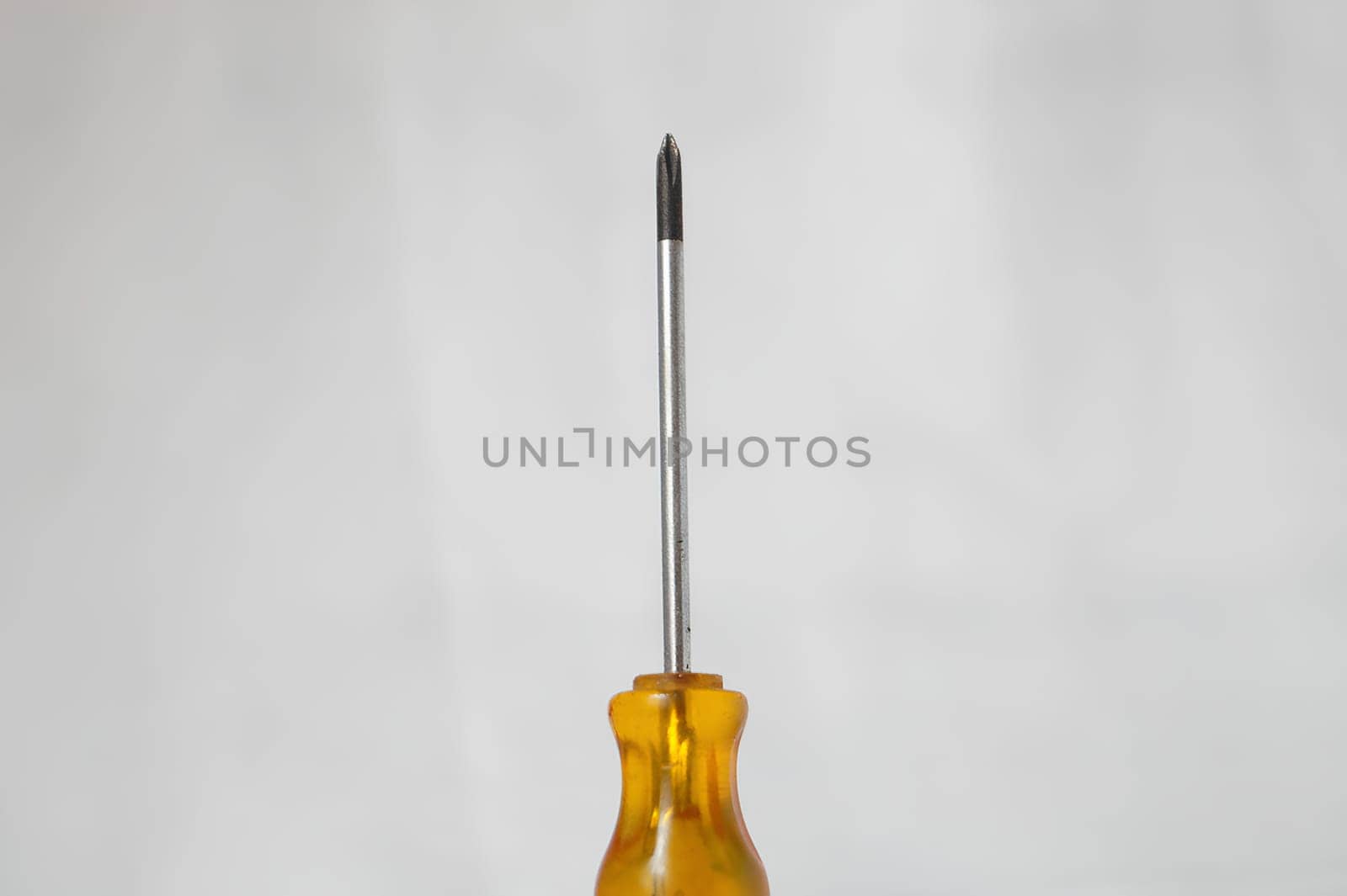 A yellow screwdriver with a silver tip. High quality photo