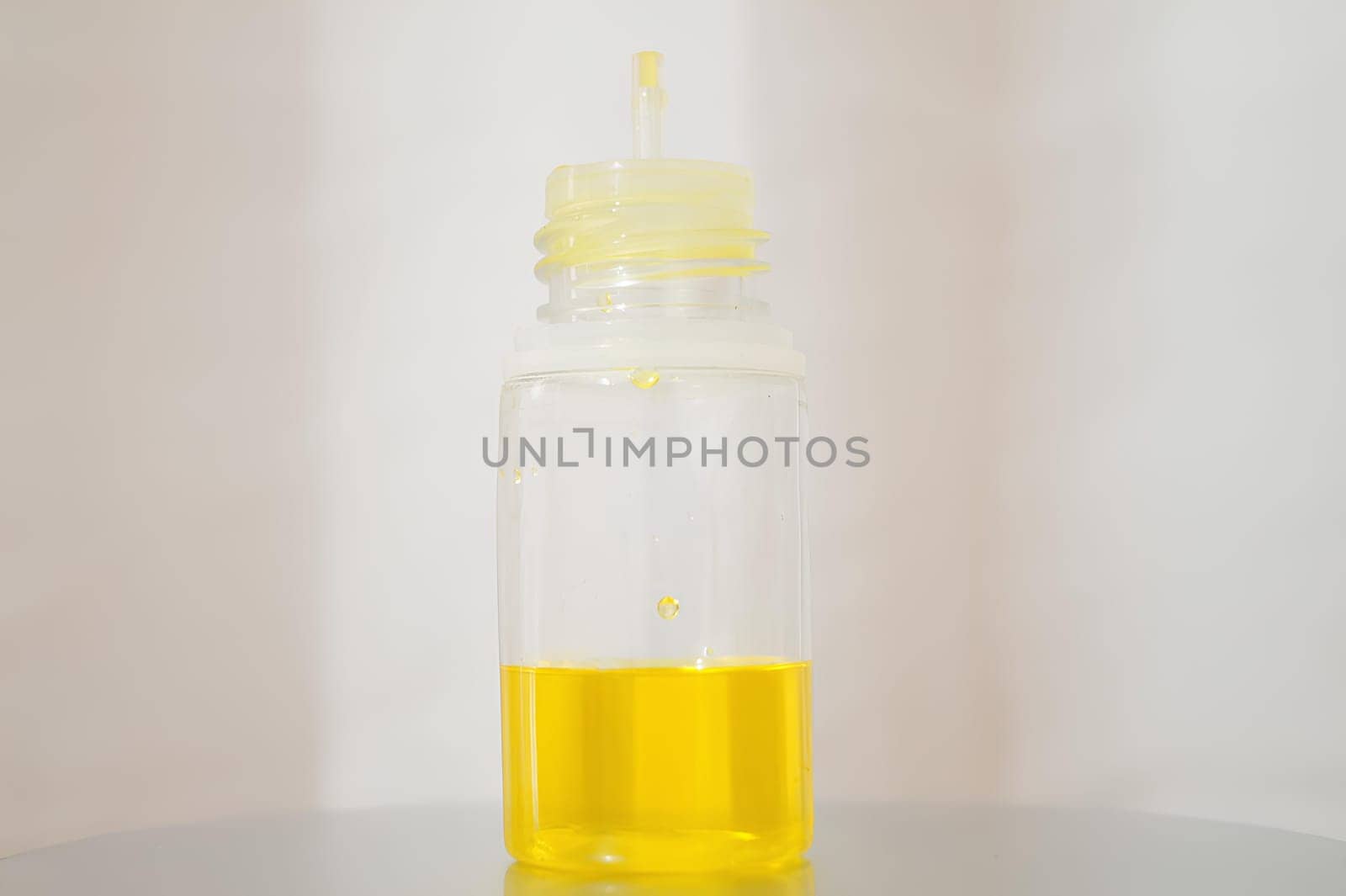 Bottle of Sunshine Yellow Liquid in a Yellow Bottle. High quality photo