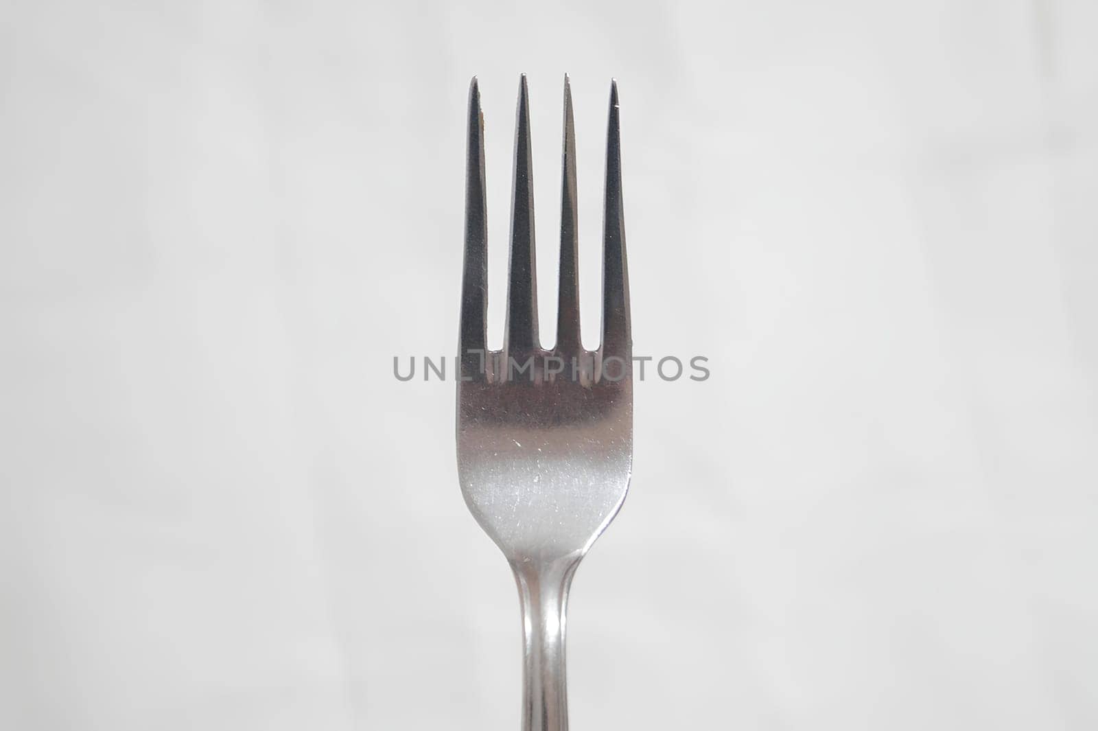 A fork is shown in a close up shot. High quality photo