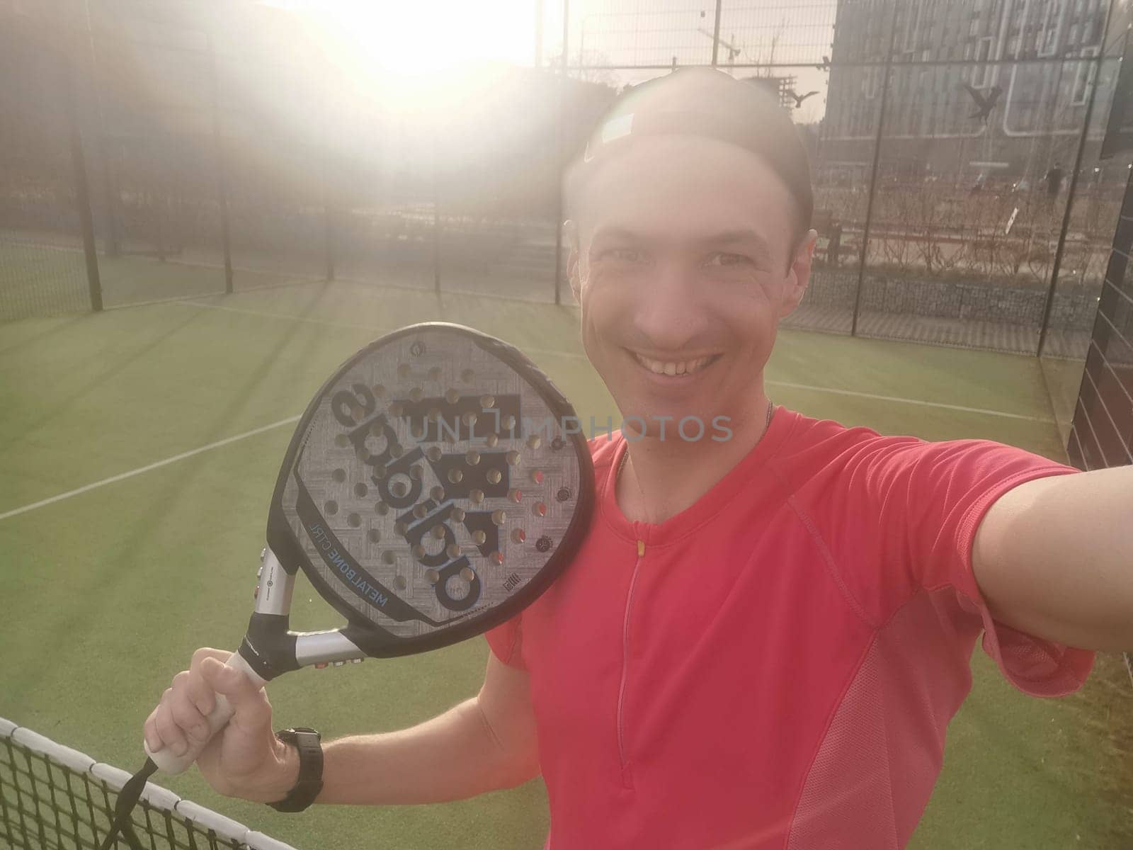 Ukraine Kyiv, April 02 2024. a man holds an adidas padel tennis racket. High quality photo