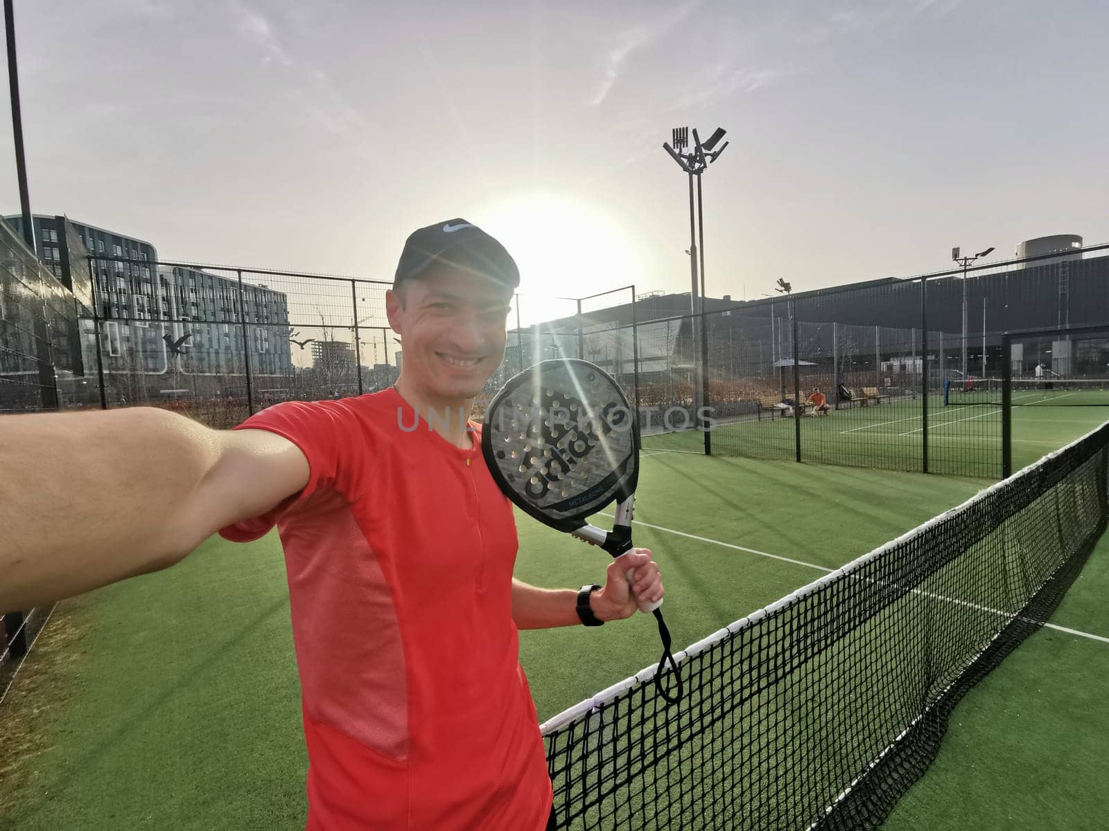 Ukraine Kyiv, April 02 2024. a man holds an adidas padel tennis racket. High quality photo