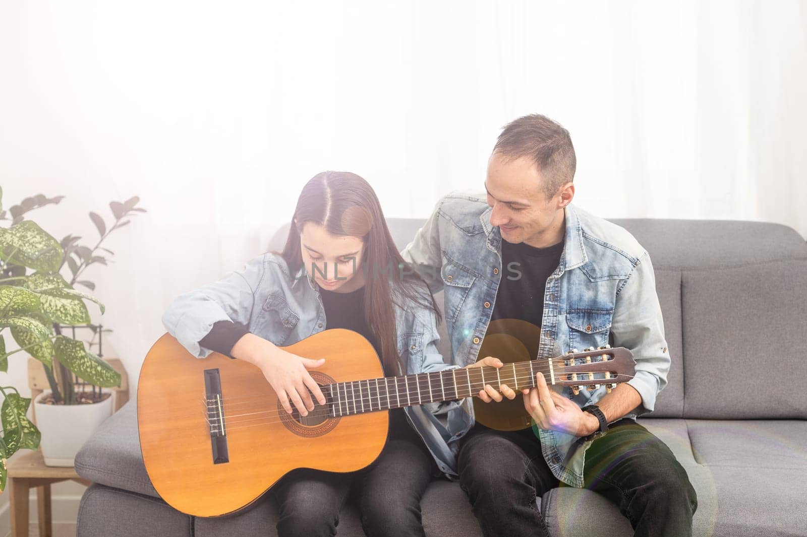 Guitar teacher teaching the little girl. High quality photo