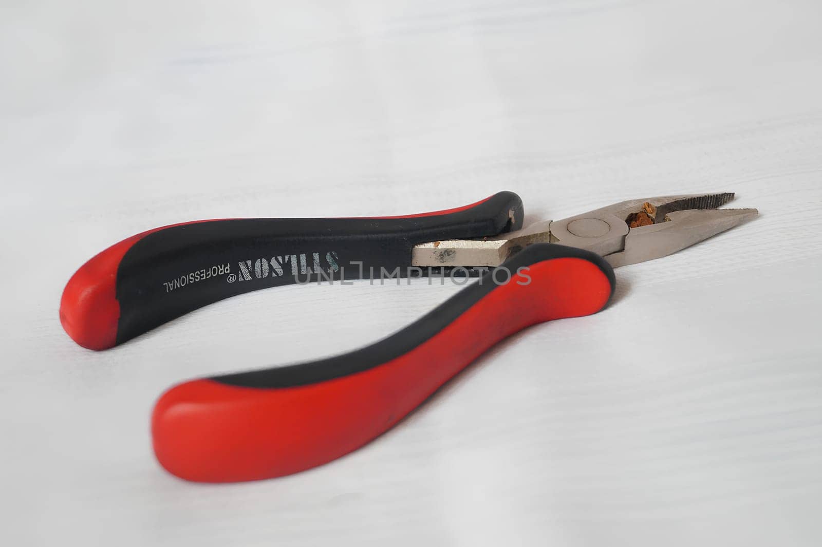 A pair of plier on the handle. High quality photo