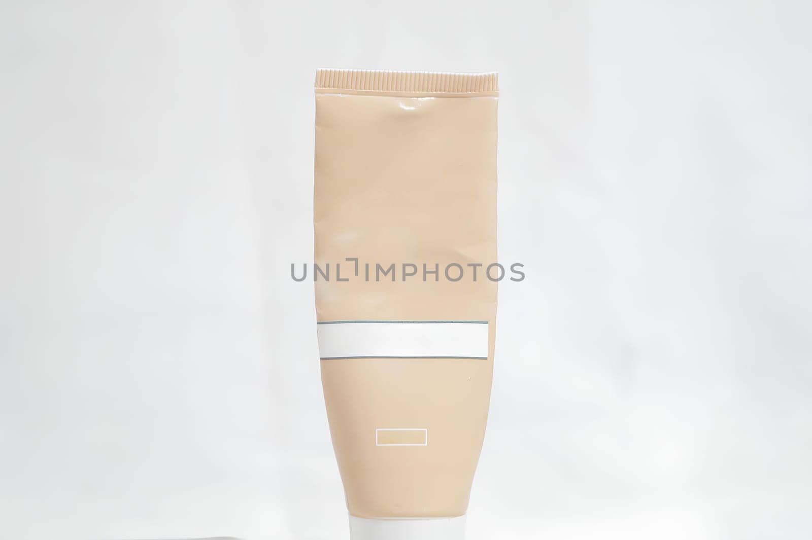 A tube of cream is sitting on a white background. High quality photo
