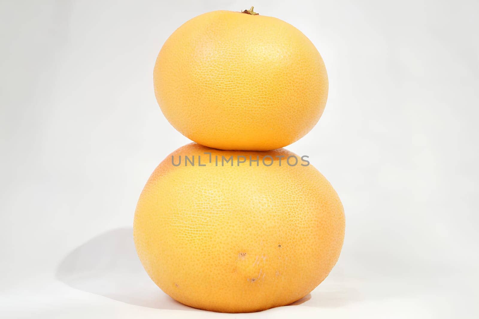 A Tower of Citrus Two Stacked Grapefruits. High quality photo