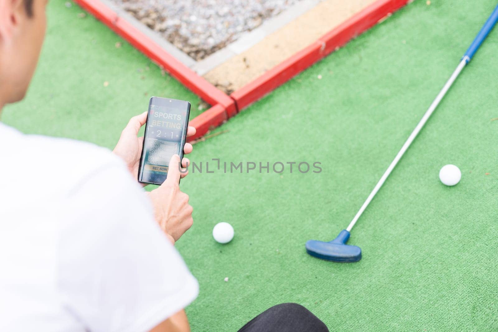 Touch screen in hand, tablet on golf club. smartphone with a sports betting application. High quality photo