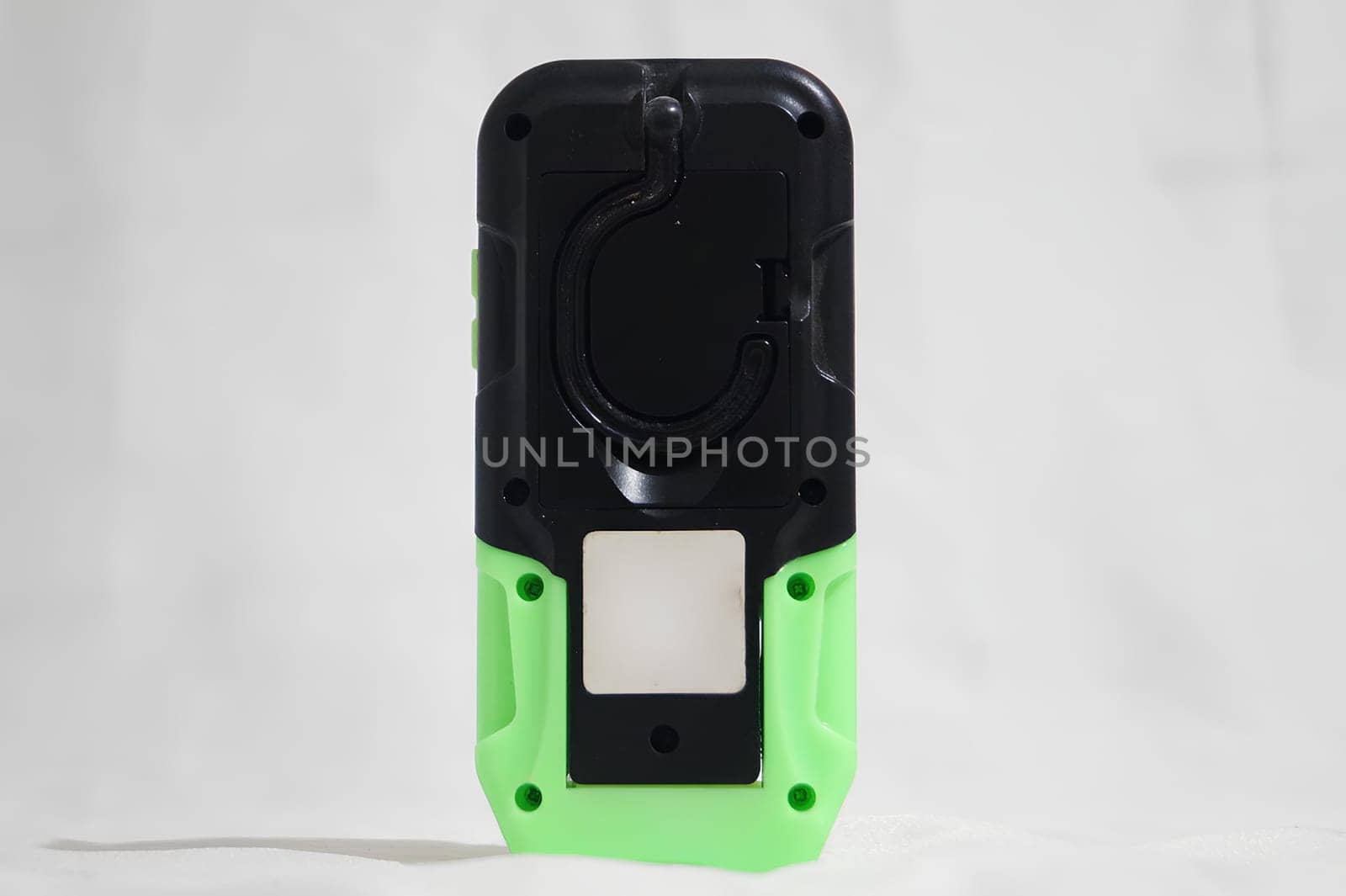 A green and black cell phone with a white background. High quality photo